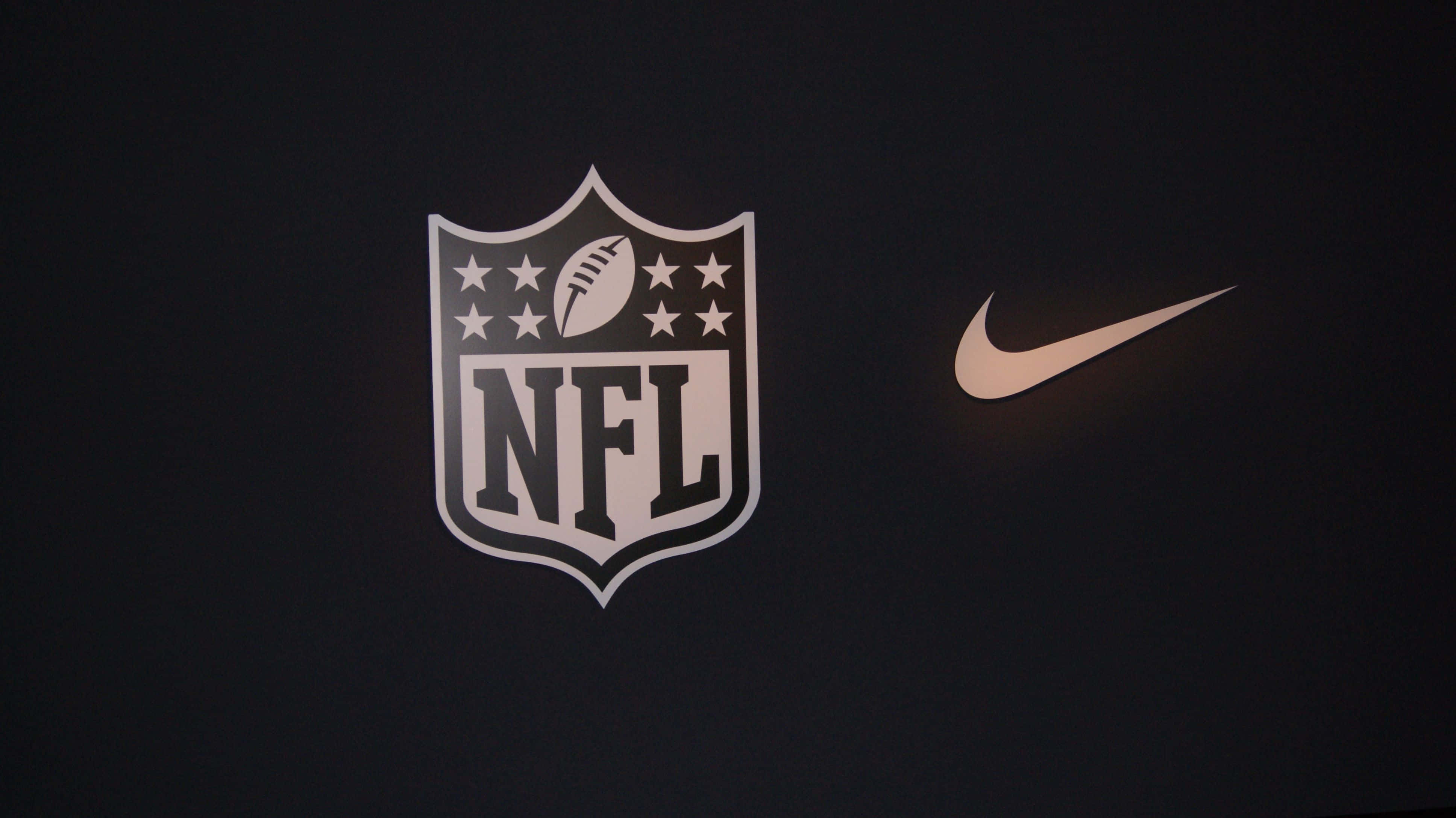 NFL 桌布 壁紙 — NFL標誌和Nike勾勾在深色背景上以白色和金色照亮。