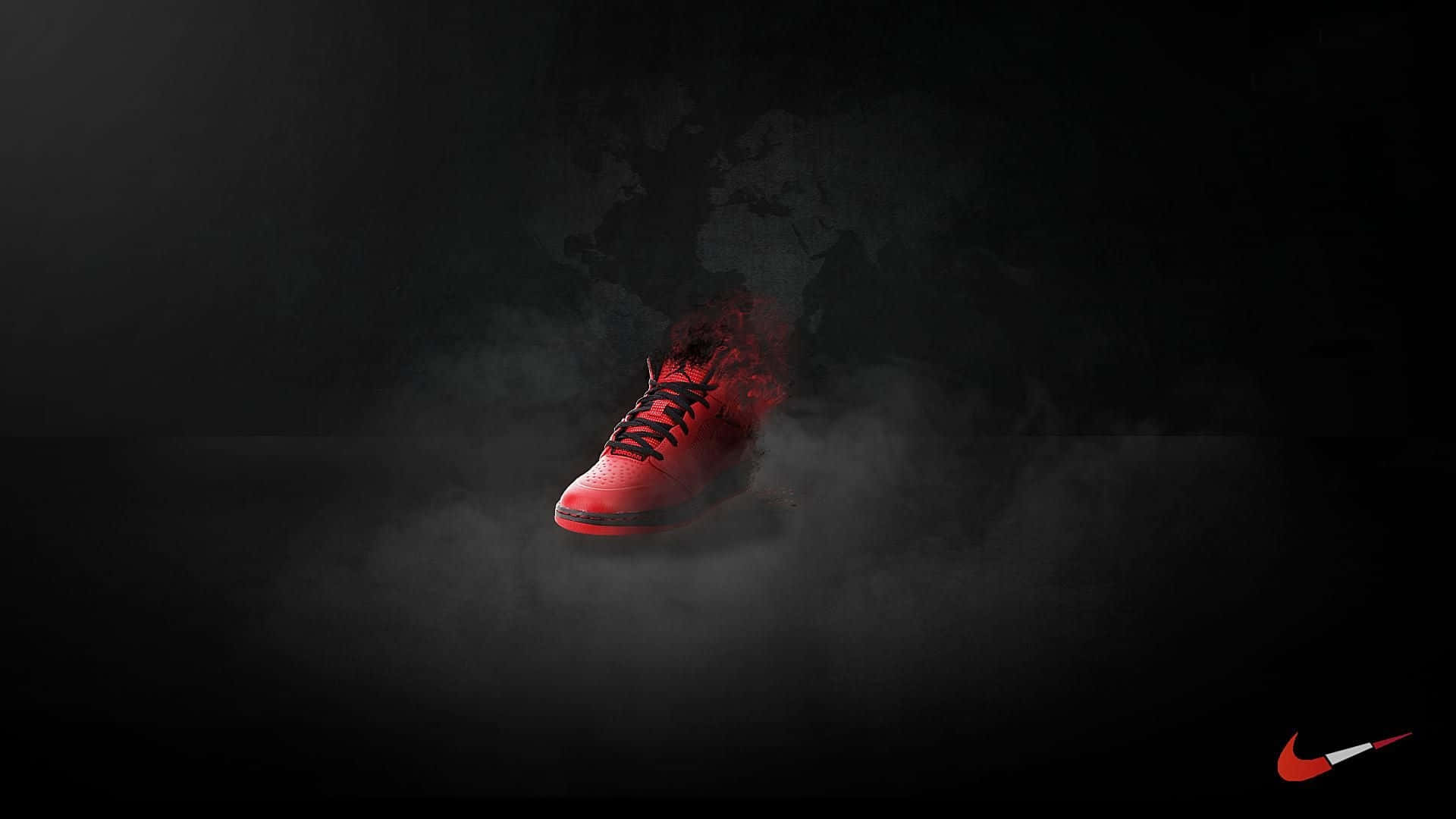 炫目紅色Nike運動鞋上陣 壁紙 — 一雙發光的紅色運動鞋從黑煙中顯現，背景是黑色並帶有模糊的世界地圖輪廓。