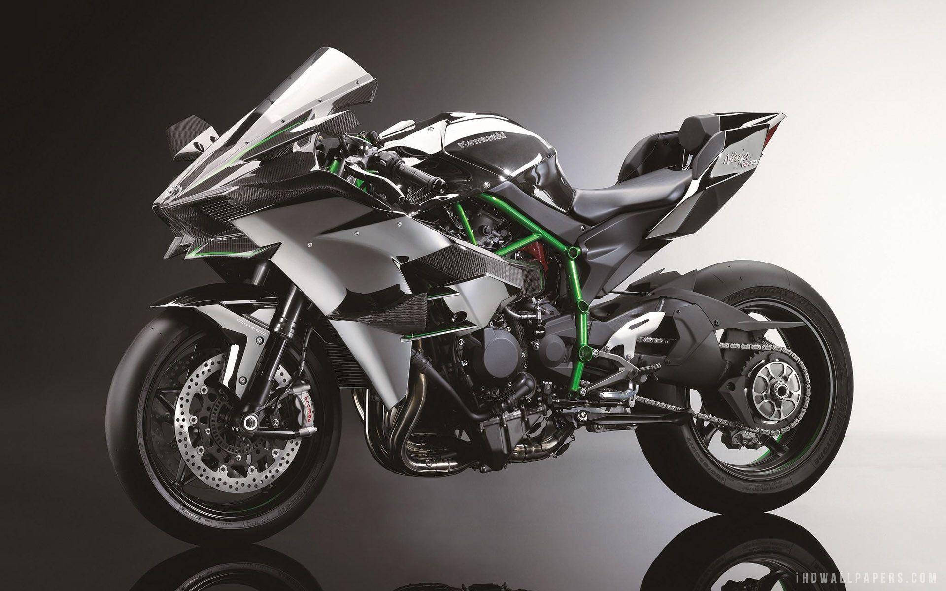 川崎展覽Ninja H2r 壁紙 — 一架光滑的銀黑色川崎運動電單車，帶有綠色點綴，立於反射的攝影棚地板上，背景為漸變灰色。