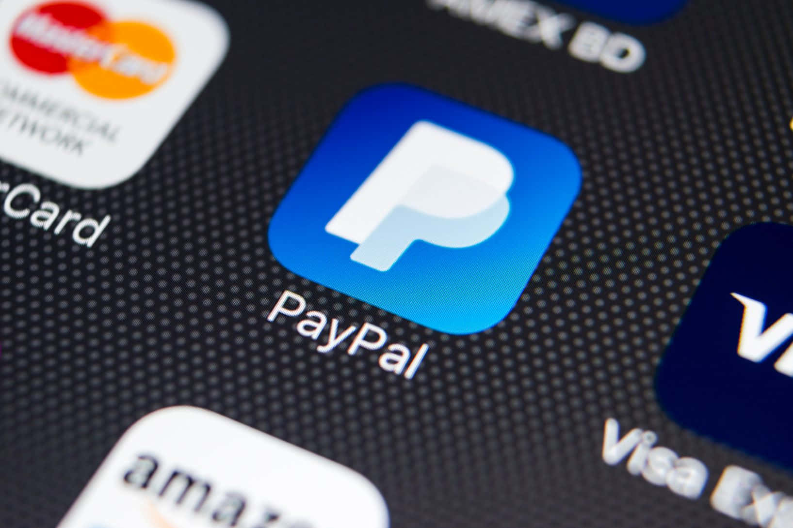 加入全球數百萬接受 PayPal 付款的商家行列 壁紙 — 智能手機屏幕特寫，顯示PayPal應用程式圖標與其他支付應用程式（如Mastercard和Visa）一起。