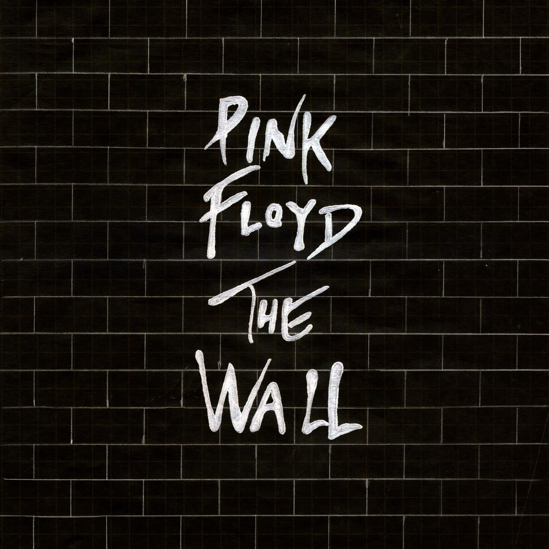 Pink Floyd The Wall 專輯封面，黑色瓷磚牆上有白色手寫文字。