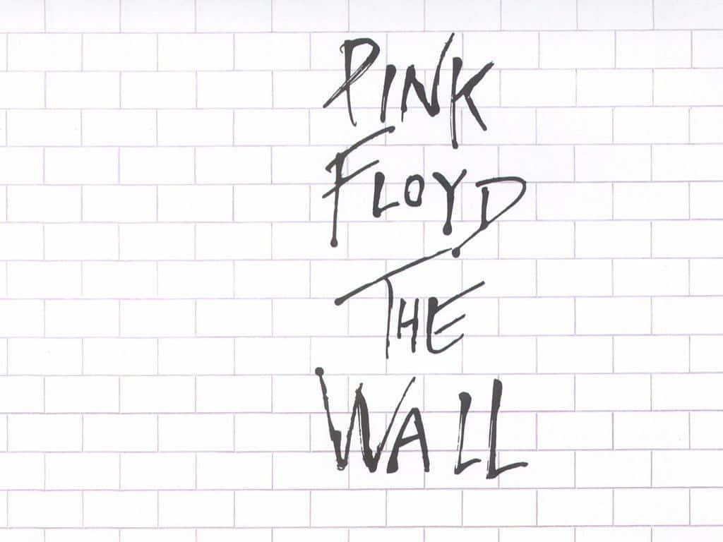 用黑色馬克筆在白色瓷磚牆上寫的Pink Floyd The Wall。