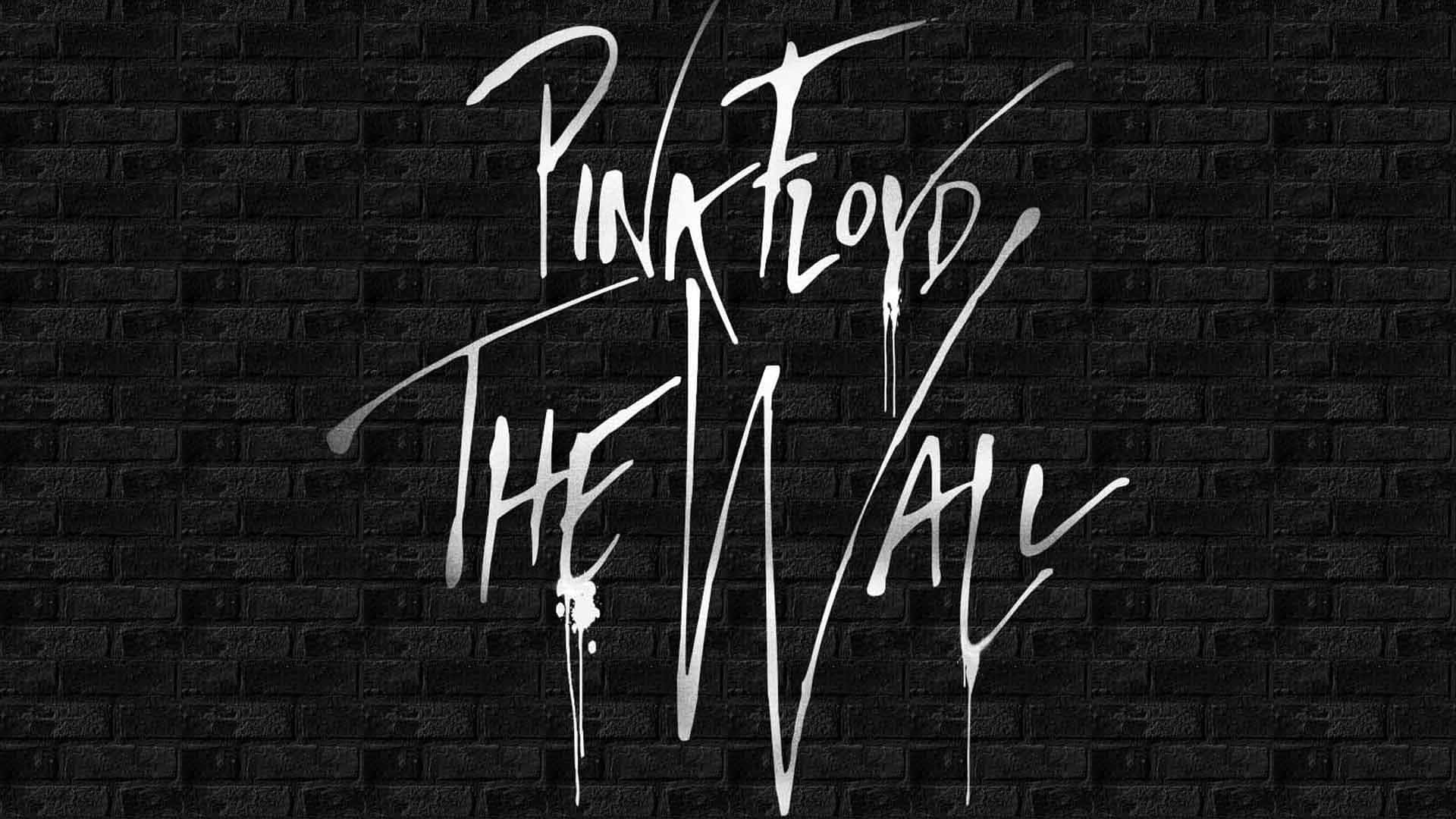 Pink Floyd The Wall 專輯標題以滴落白色塗鴉形式出現在黑色磚牆上。