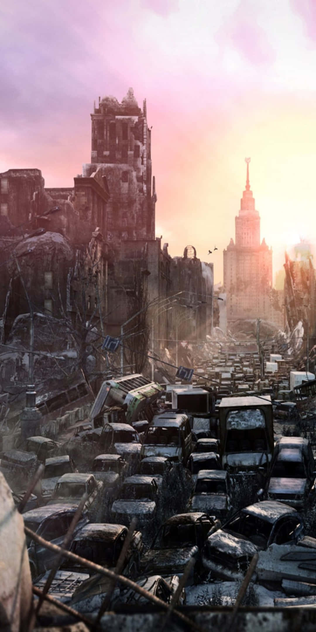 Pixel 3 突顯《Metro 2033》遊戲背景 壁紙 — 日落時分，廢墟城市景觀，倒塌的建築物和廢棄的汽車，天空呈現粉紅色和橙色。