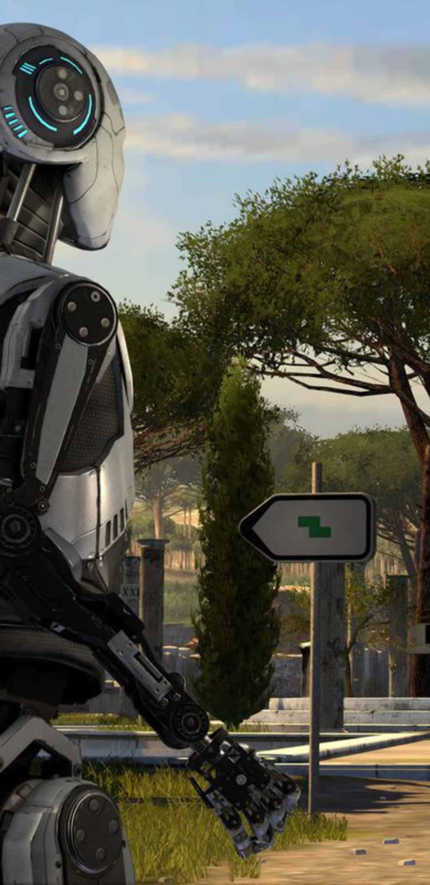 Pixel 3xl 上《The Talos Principle》的引人入勝背景 壁紙 — 一個未來風格的銀色機械人站在一個陽光普照的戶外環境中的路牌旁邊，周圍有樹木和遠處的廢墟。