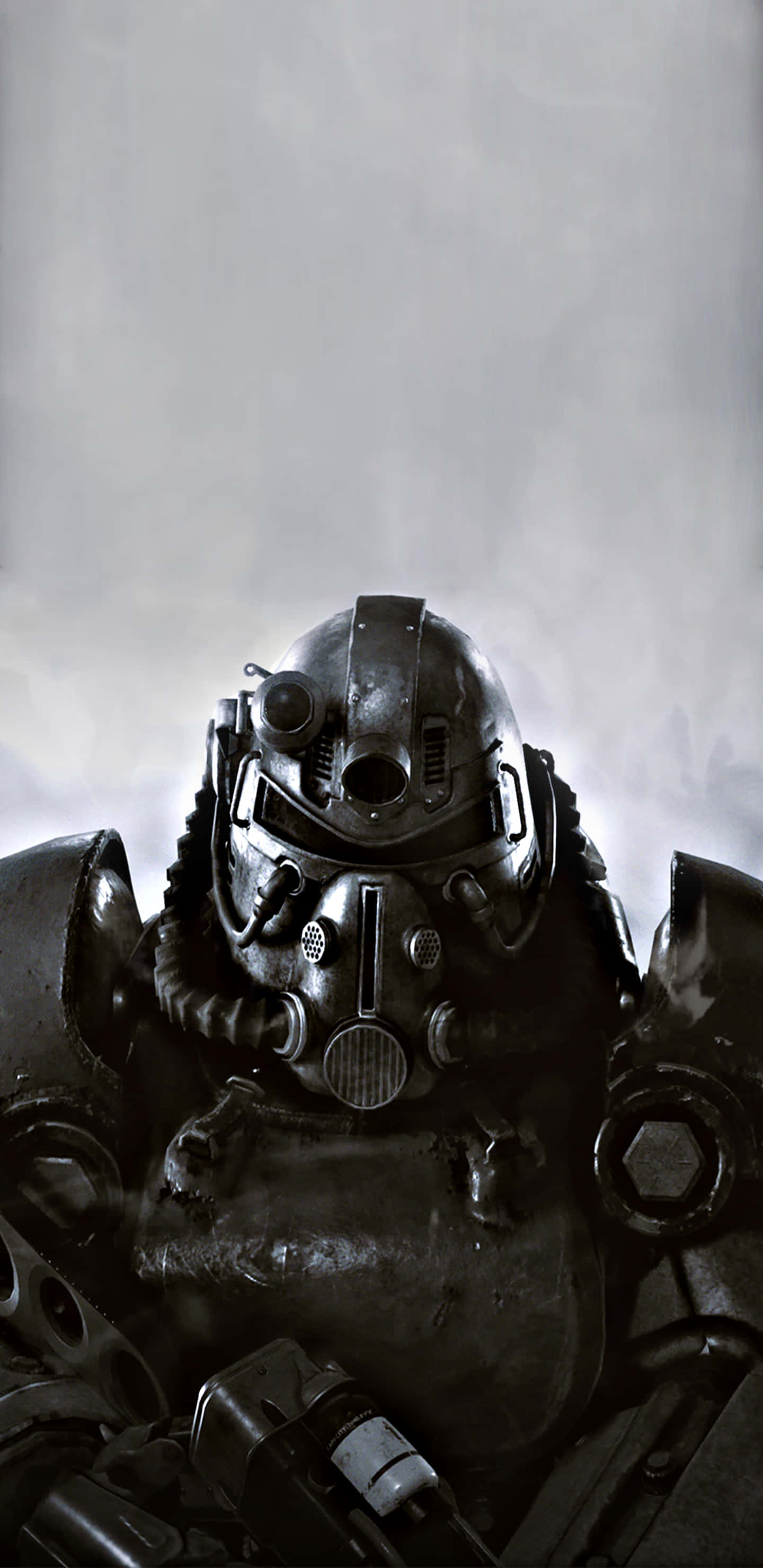Pixel 3XL 為玩家帶來 Fallout 76 的極致體驗 壁紙 — 近距離拍攝的重型裝甲動力裝甲服，配有頭盔，背景為煙霧灰色。