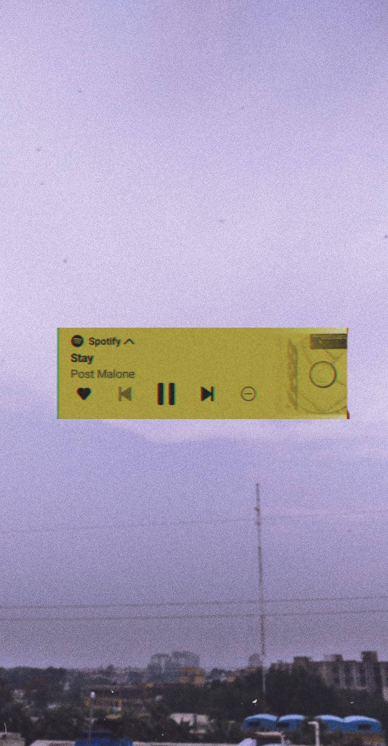 一個漂浮的Spotify音樂播放器，位於黃昏的城市天際線之上。