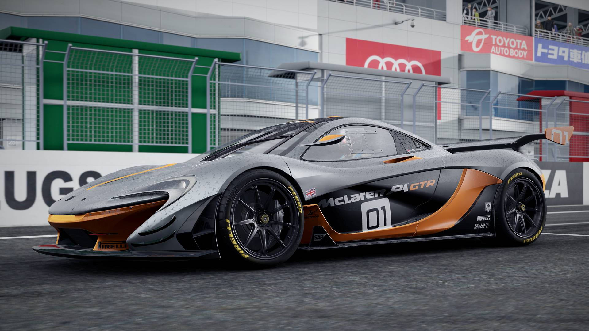銀色和橙色McLaren 01 GTR賽車在賽道上，帶有贊助商橫額。