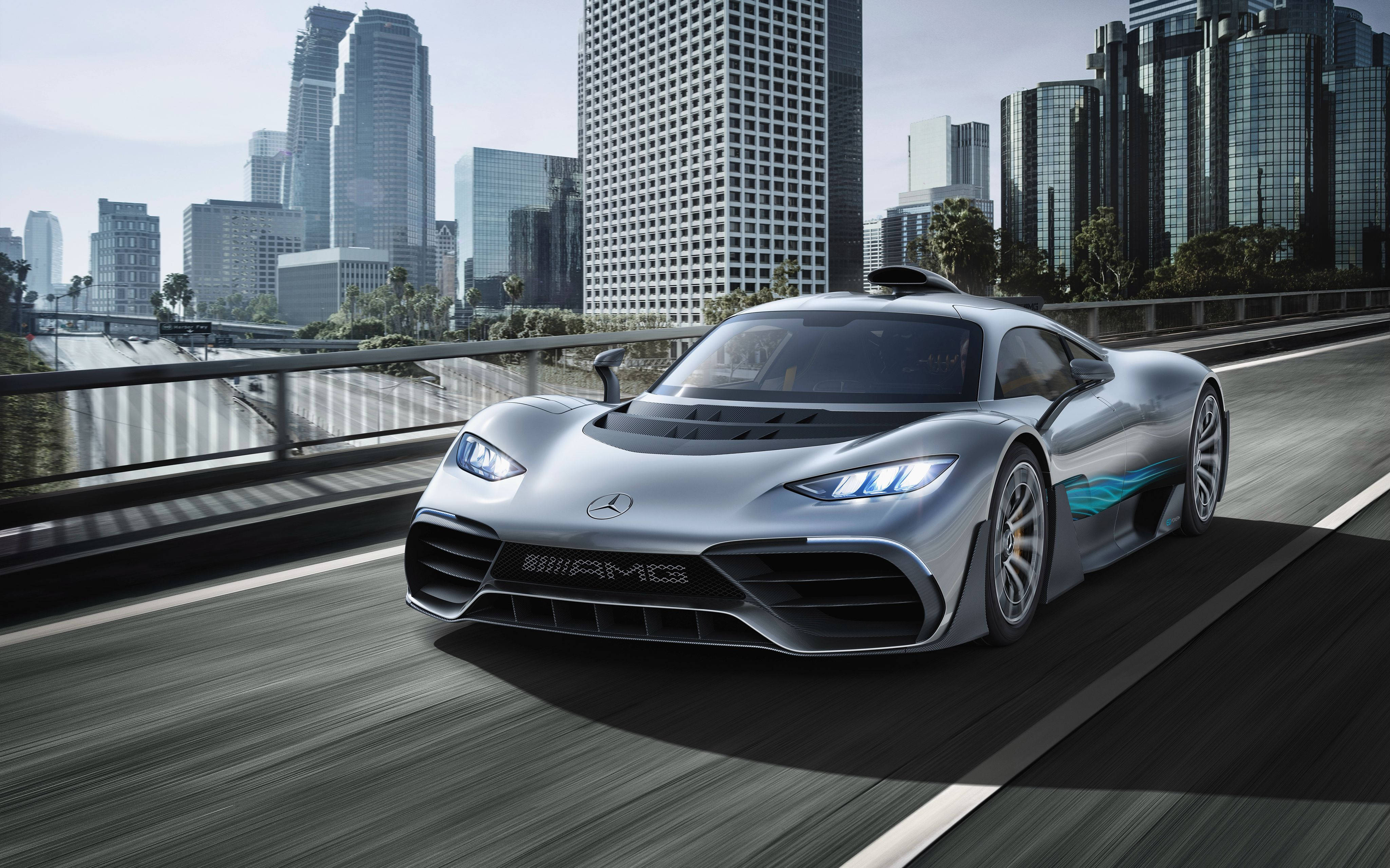 Project Cars 4K 梅賽德斯-奔馳 AMG 壁紙 — 一架時尚的銀色 Mercedes-AMG 跑車在城市橋樑上飛馳，背景是高樓大廈。