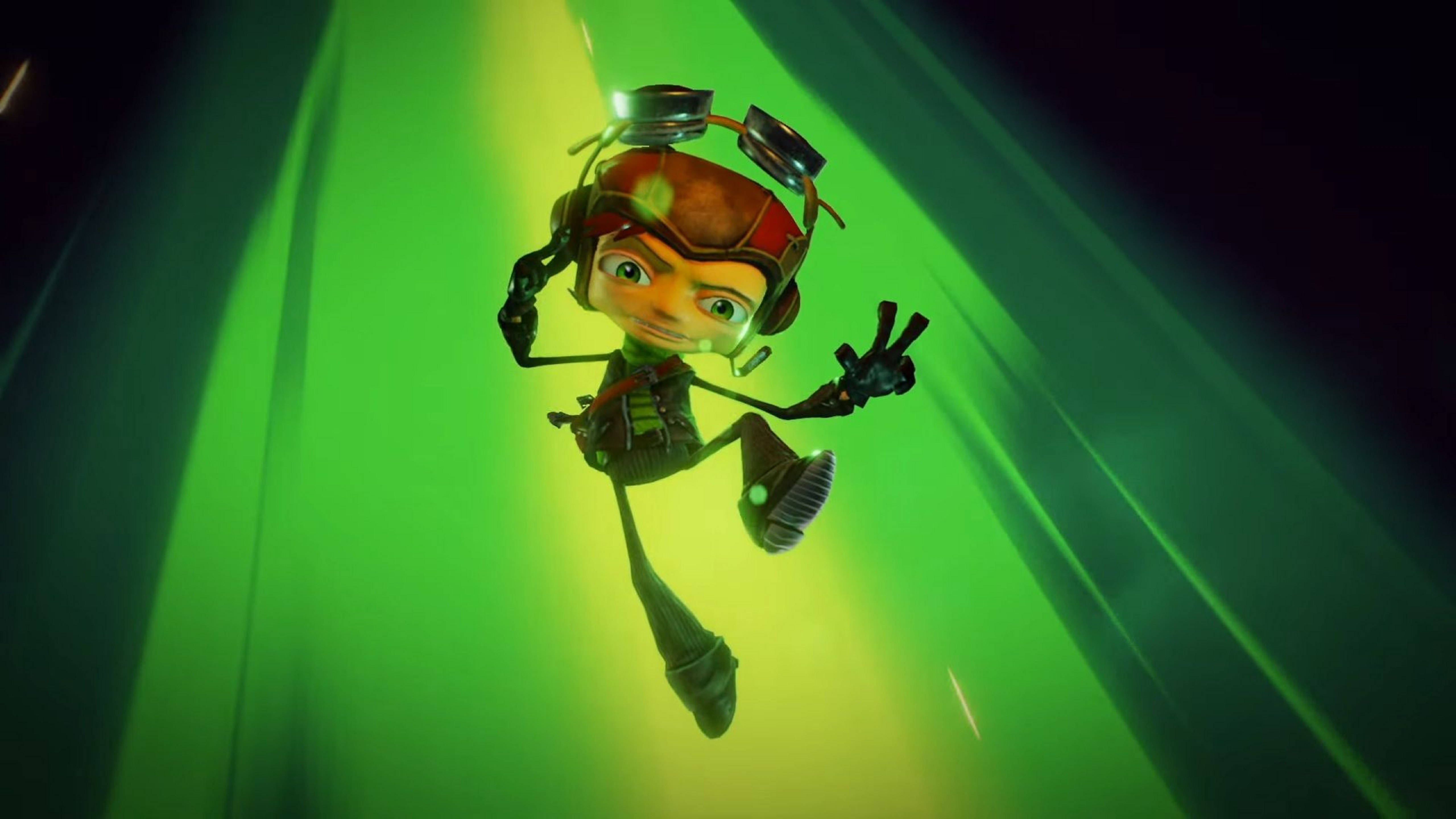 《Psychonauts 2》遊戲畫面拉茲 壁紙 — 一個戴著頭盔和護目鏡的卡通角色，愉快地漂浮在充滿活力的綠色隧道中，揮動一隻手。