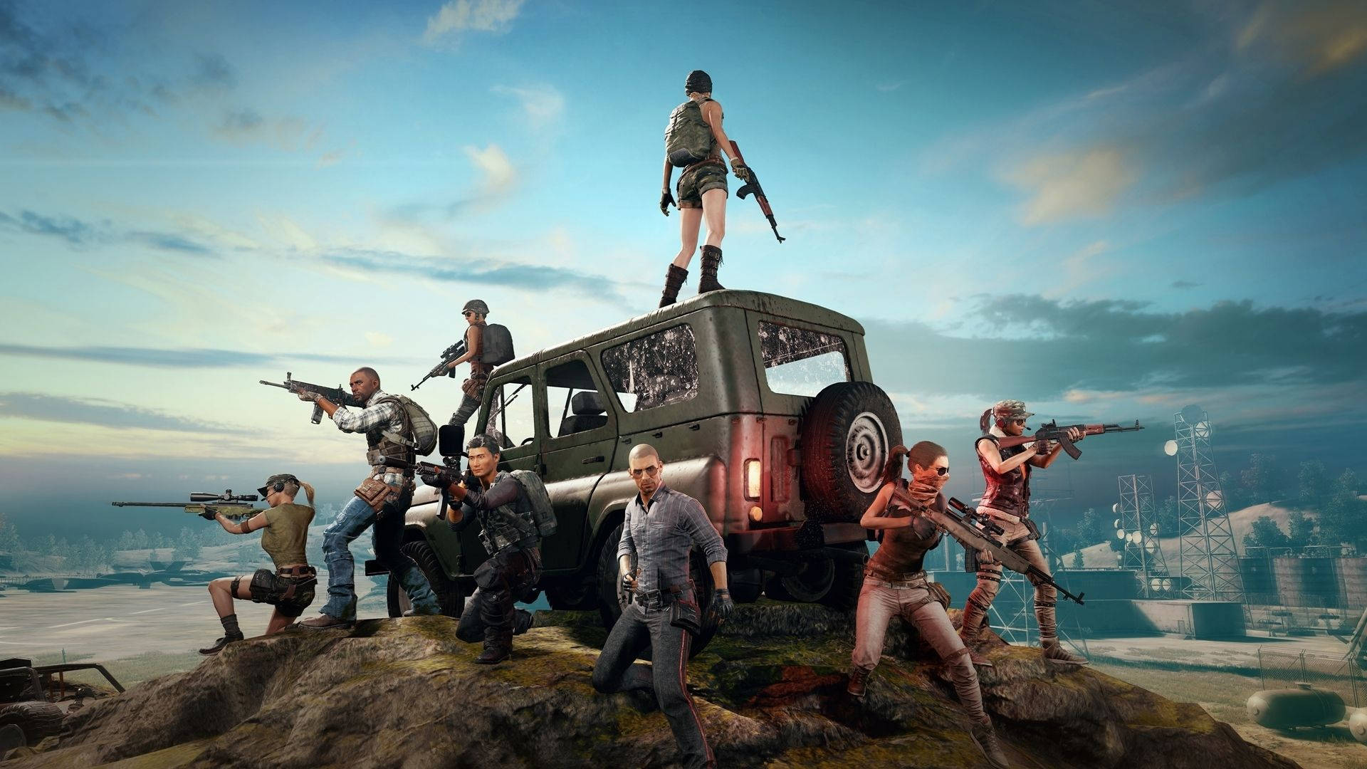 PUBG 3D 生動高清越野 壁紙 — 一群身穿戰術裝備的武裝玩家站在崎嶇懸崖上的一輛堅固吉普車上，俯瞰黃昏時分荒涼的工業景觀。