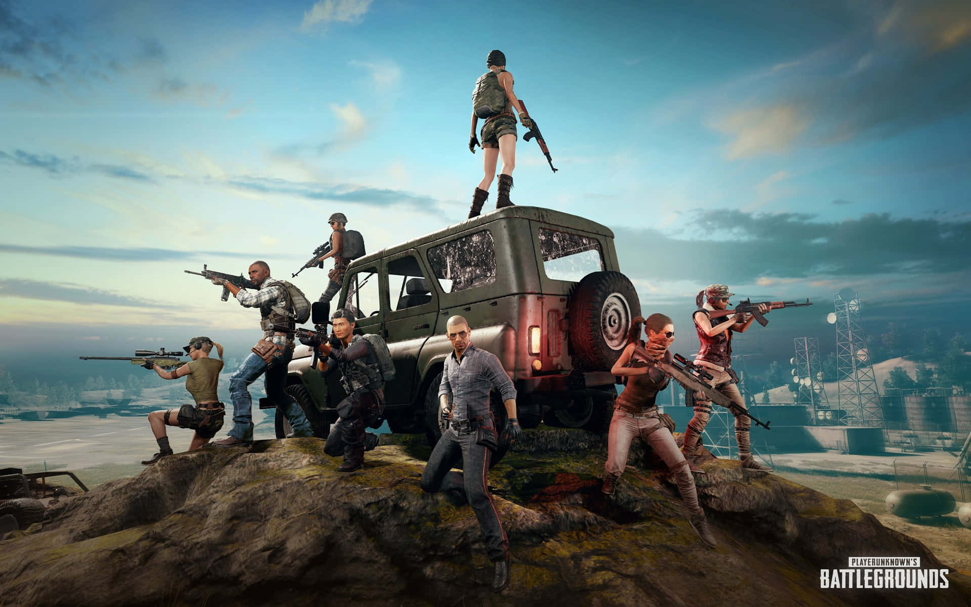 PUBG中激烈戰鬥的火焰 壁紙 — 一群武裝玩家在PUBG中站在岩石山丘上，俯瞰夕陽下遠處的工業區。