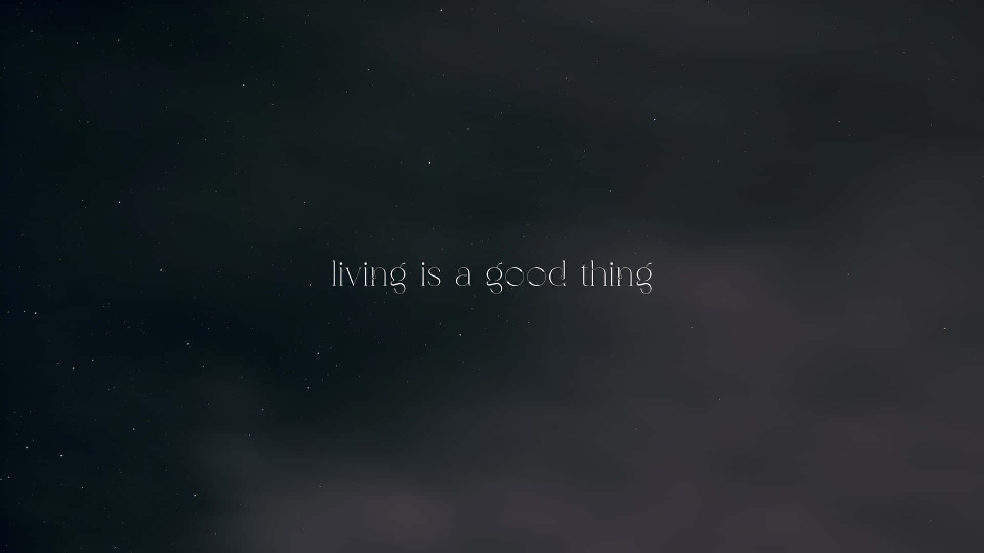  壁紙 — 漆黑的星空，帶有微弱的雲層，並以白色文字寫著 living is a good thing。