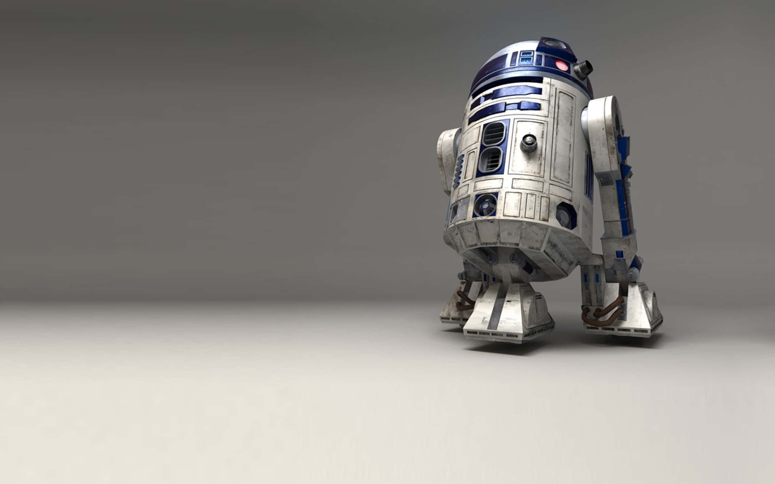 R2-D2 主導大局 壁紙 — 一個詳細的3D渲染，呈現標誌性的R2-D2機器人獨自站在樸素的灰色工作室地板上。