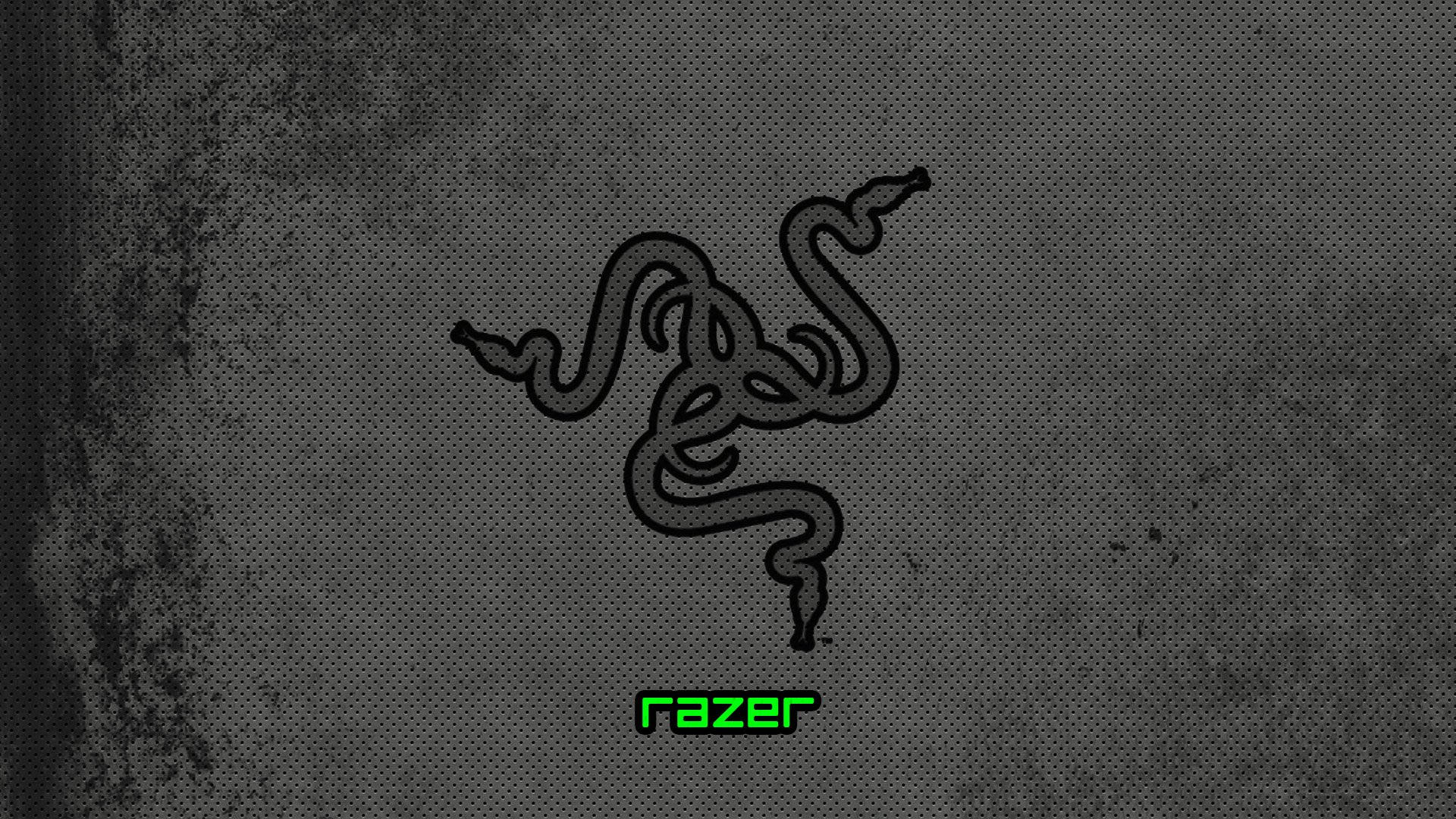 灰階點狀 Razer PC 標誌 壁紙 — 一個黑色Razer標誌，帶有發光綠色文字，位於帶有細微磨損效果的紋理深灰色背景上。