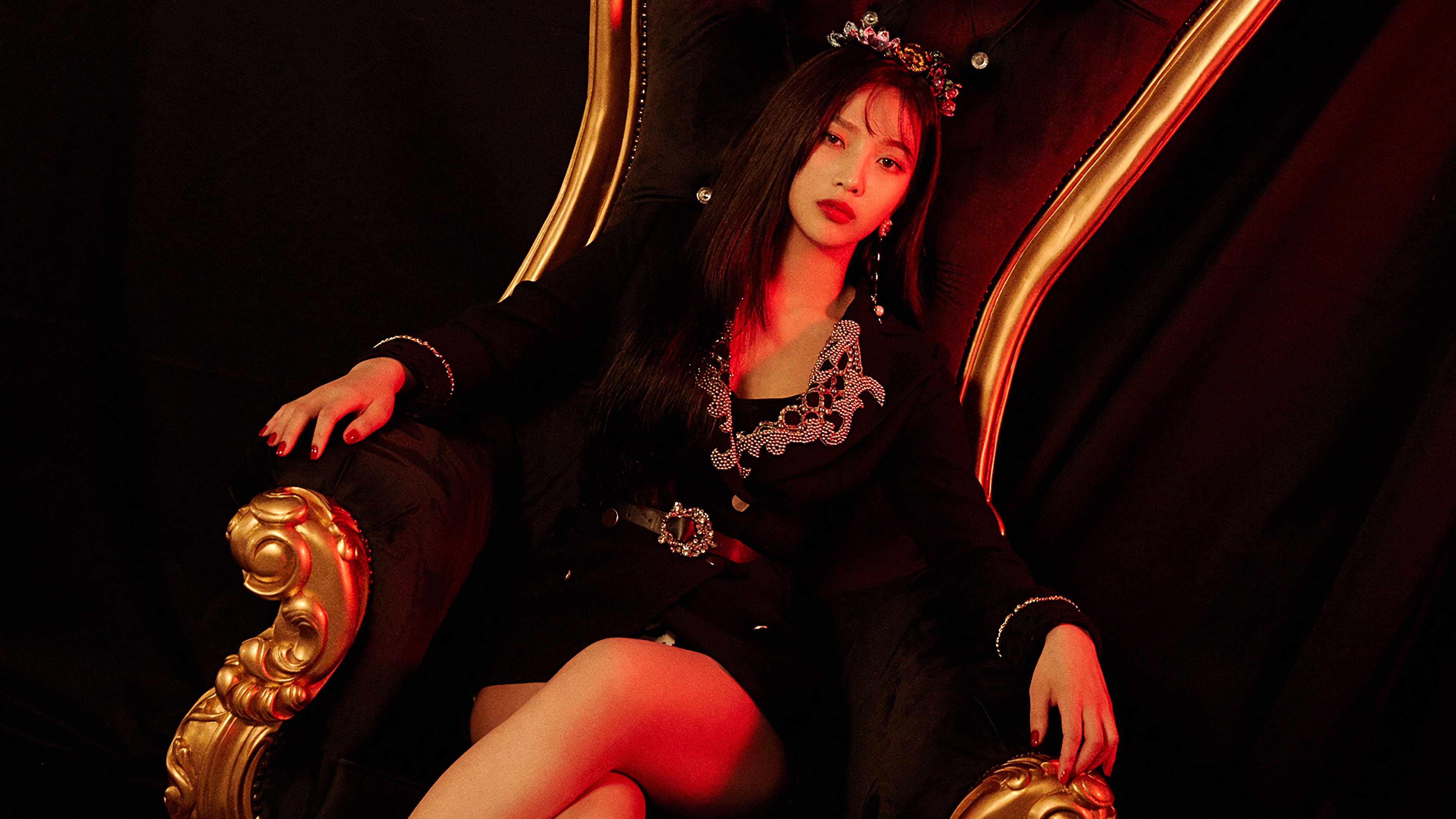 Red Velvet 成員 Joy Supremacy 壁紙 — 一位身穿黑色服裝、頭戴鑲寶石皇冠的女性，在紅色燈光的黑暗背景下，威嚴地坐在金色王座上。