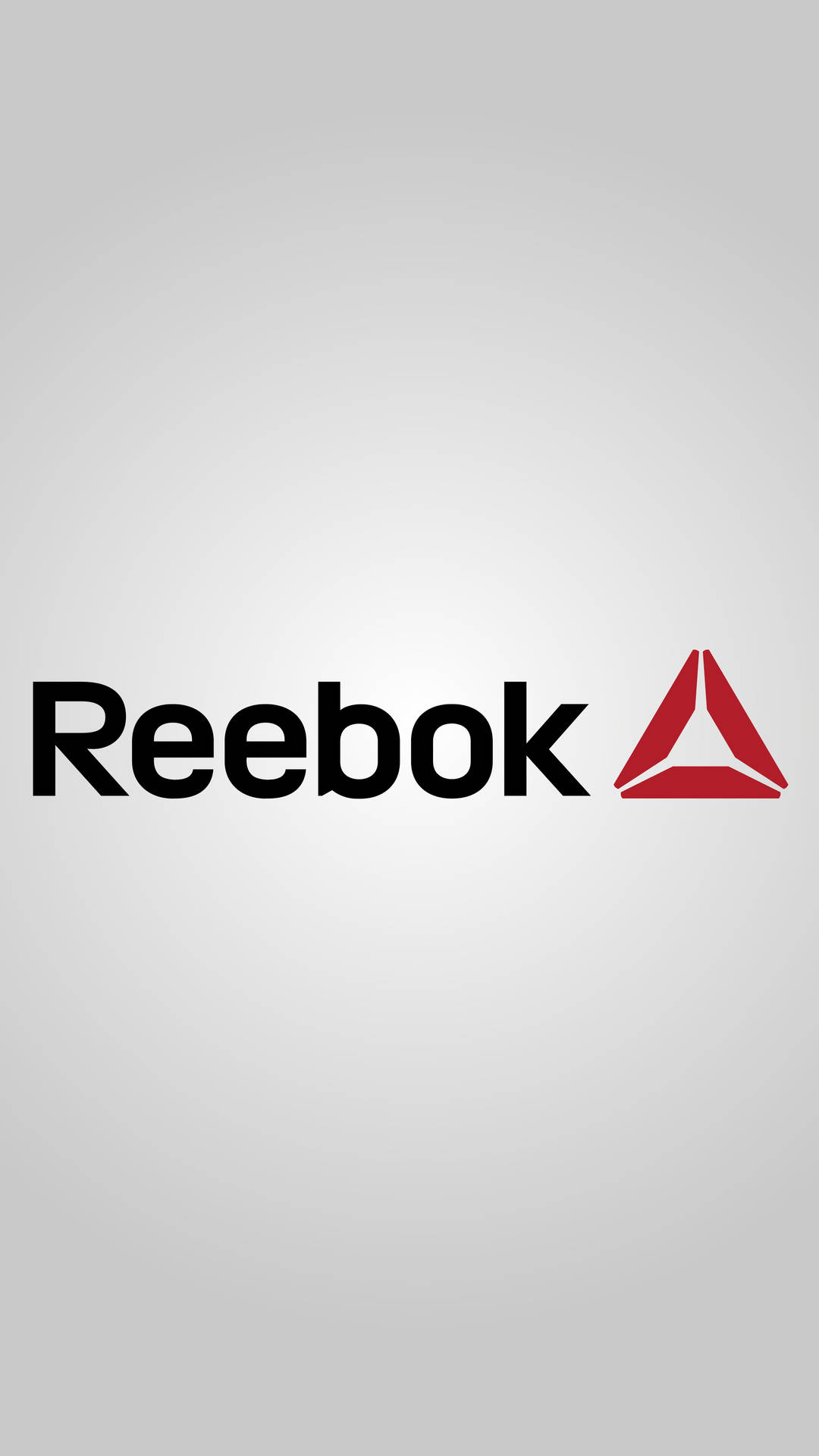 Reebok品牌標誌，黑色文字和紅色三角形在灰色背景上。