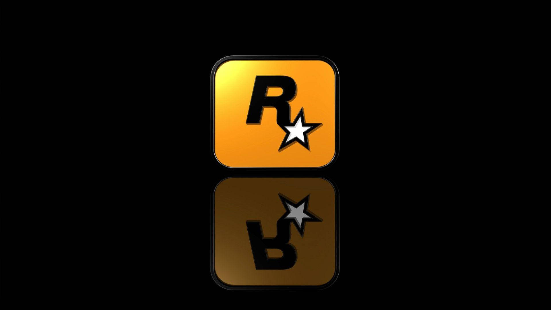 Gamer Logo 桌布 壁紙 — Rockstar Games 標誌在黑色背景上閃耀金色光芒，下方有鏡面倒影。