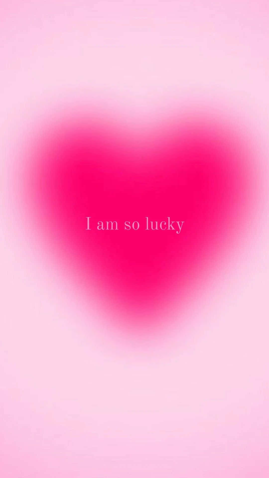 一個發光的粉紅色心形，帶有文字 I am so lucky — 粉紅色心形動圖 壁紙