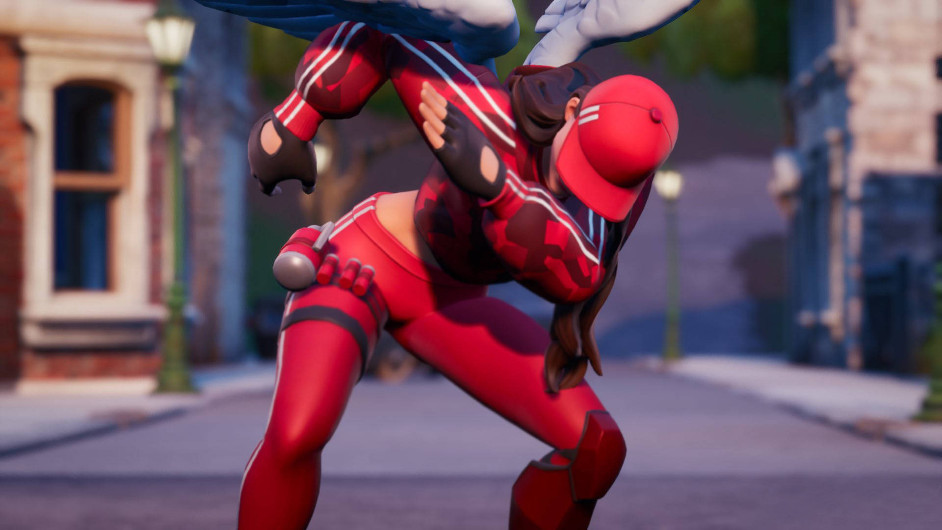 Ruby《Fortnite》Dab 姿勢 壁紙 — 身穿紅色套裝的女超級英雄在城市街道上空以空中戰鬥姿勢出現，街道上有磚砌建築和路燈。