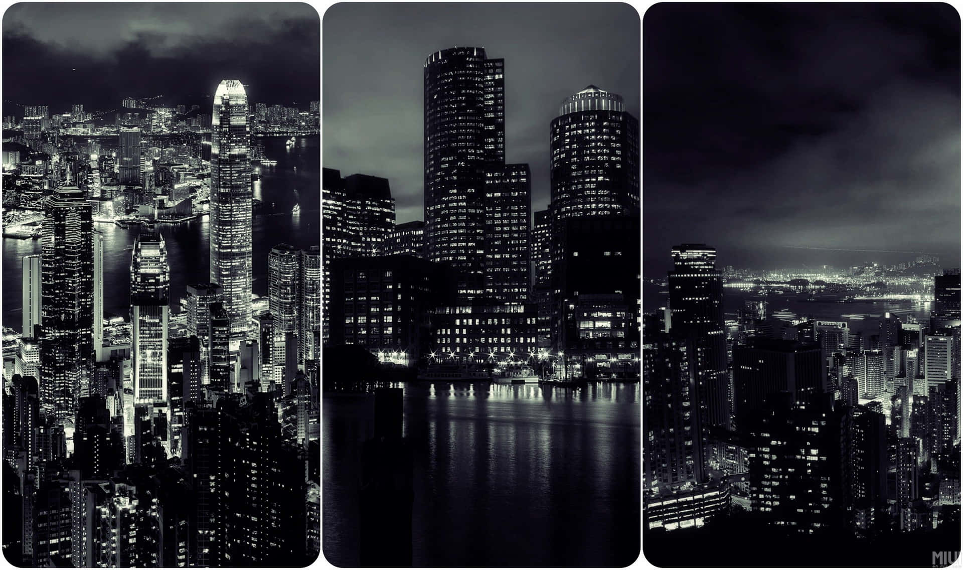 黑白夜景城市景觀，高樓大廈與水面倒影。
