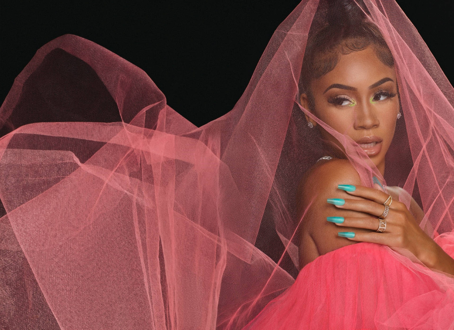 Saweetie 粉紅色攝影棚 壁紙 — 一位身穿飄逸粉紅面紗和相配連衣裙的女性，在黑色背景下，搭配充滿活力的藍綠色指甲，若有所思地凝視著。