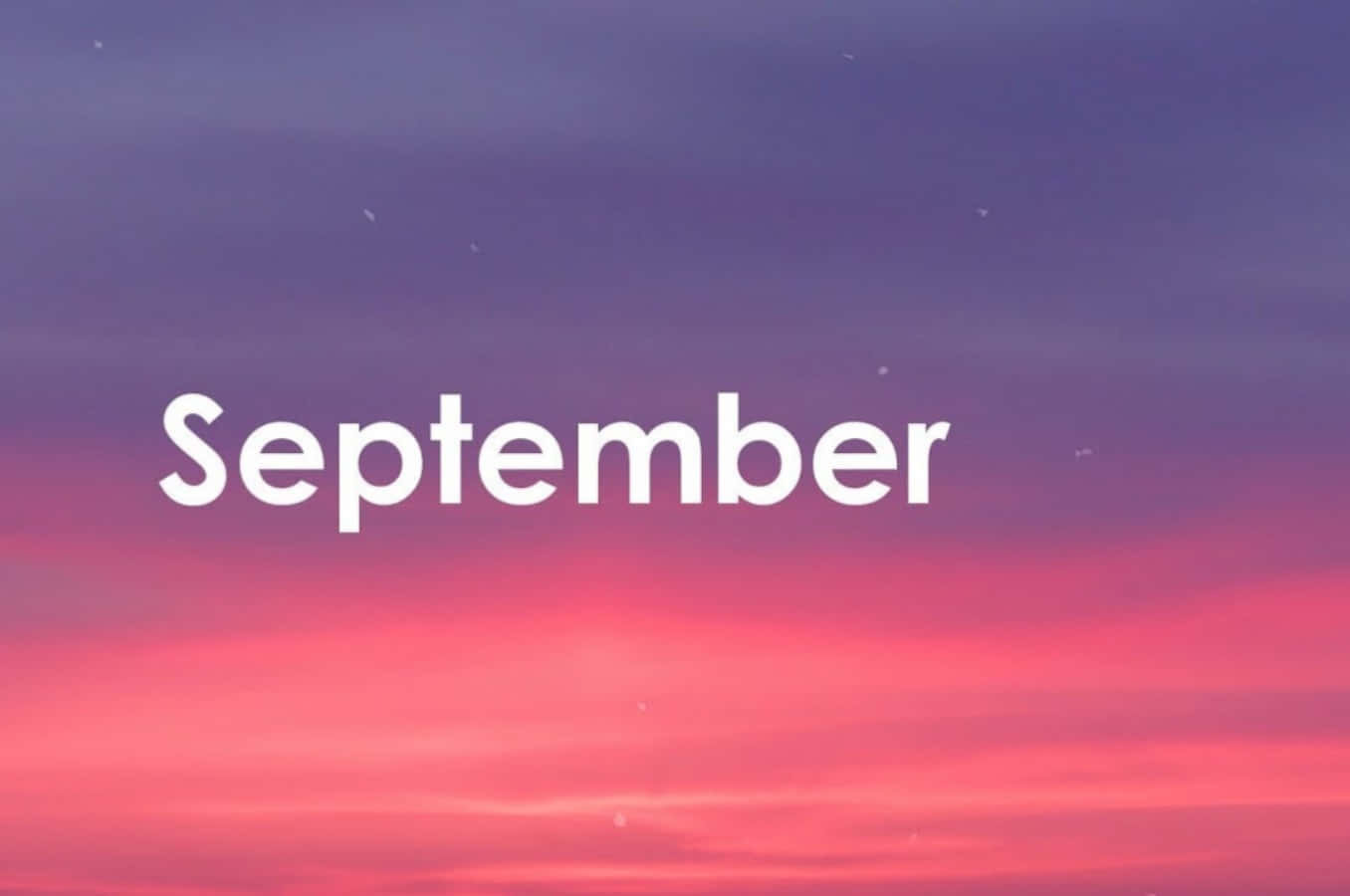 九月 桌布 壁紙 — 「September」一詞漂浮在黃昏時分紫色和粉紅色的漸變天空中。