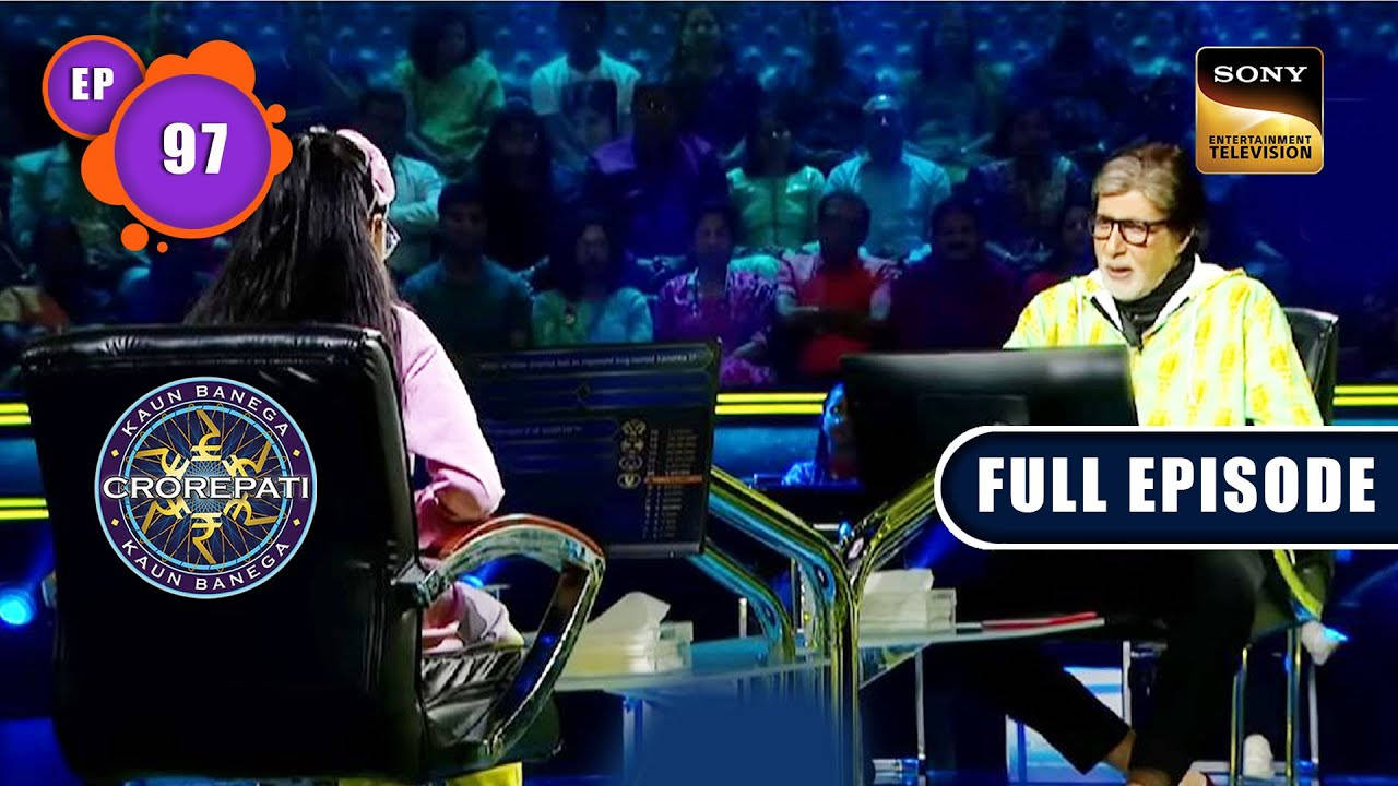 SET India 電視節目《KBC》阿米塔布·巴強與參賽者 壁紙 — 主持人 Amitabh Bachchan 與參賽者在燈光明亮的 Kaun Banega Crorepati 佈景中對決，背景有觀眾。