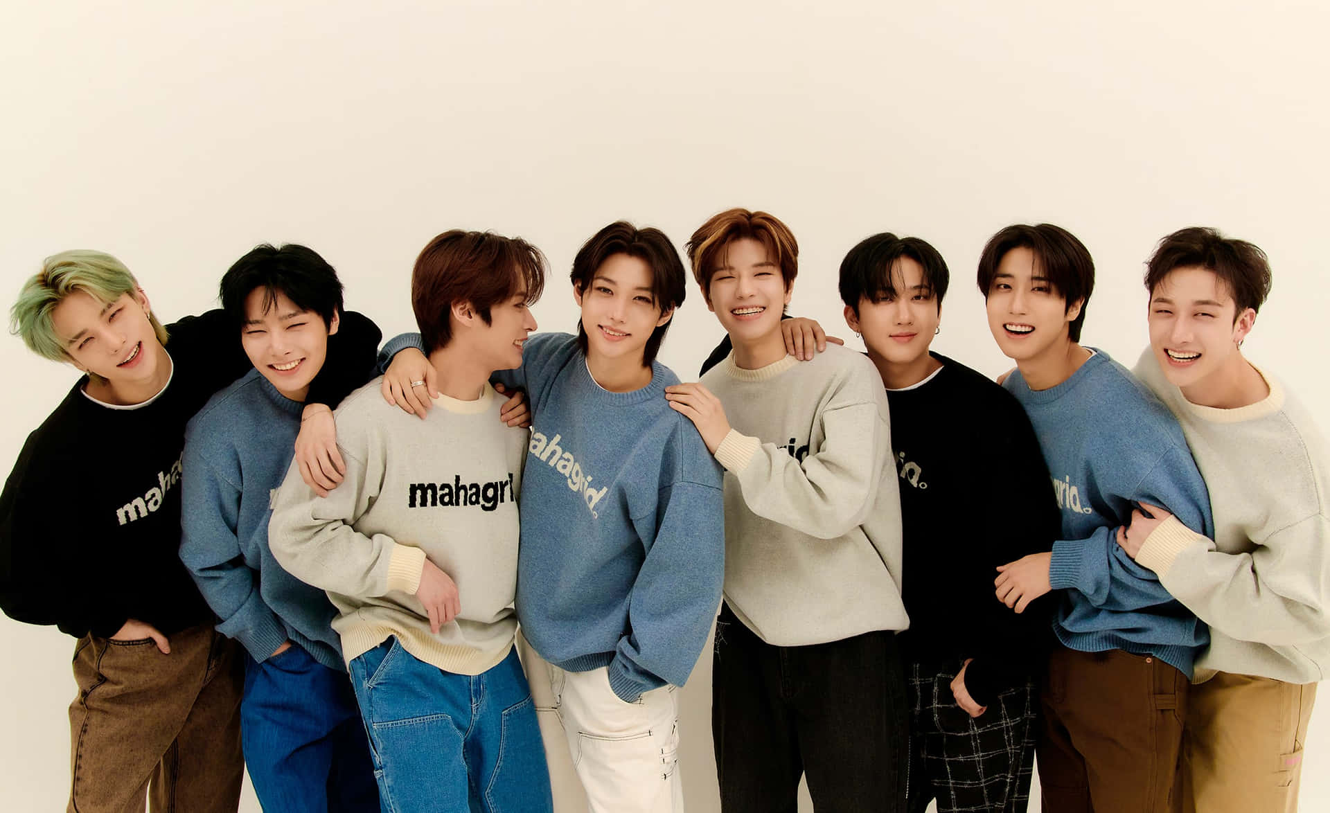 七位穿著休閒服的年輕男性在攝影棚中微笑並一起擺姿勢。 — Stray kids GIF 壁紙