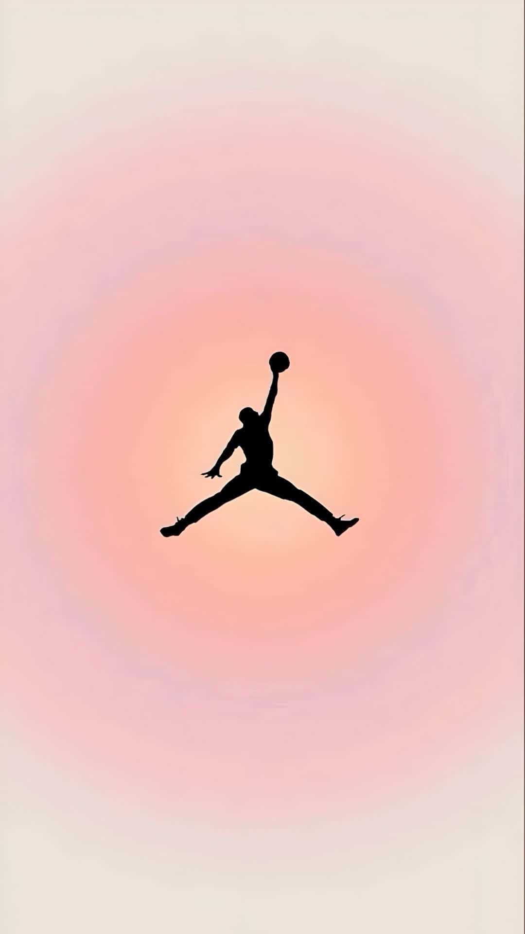  壁紙 — 一個籃球運動員在半空中入樽的剪影，背景是柔和粉紅色漸變的日落天空。