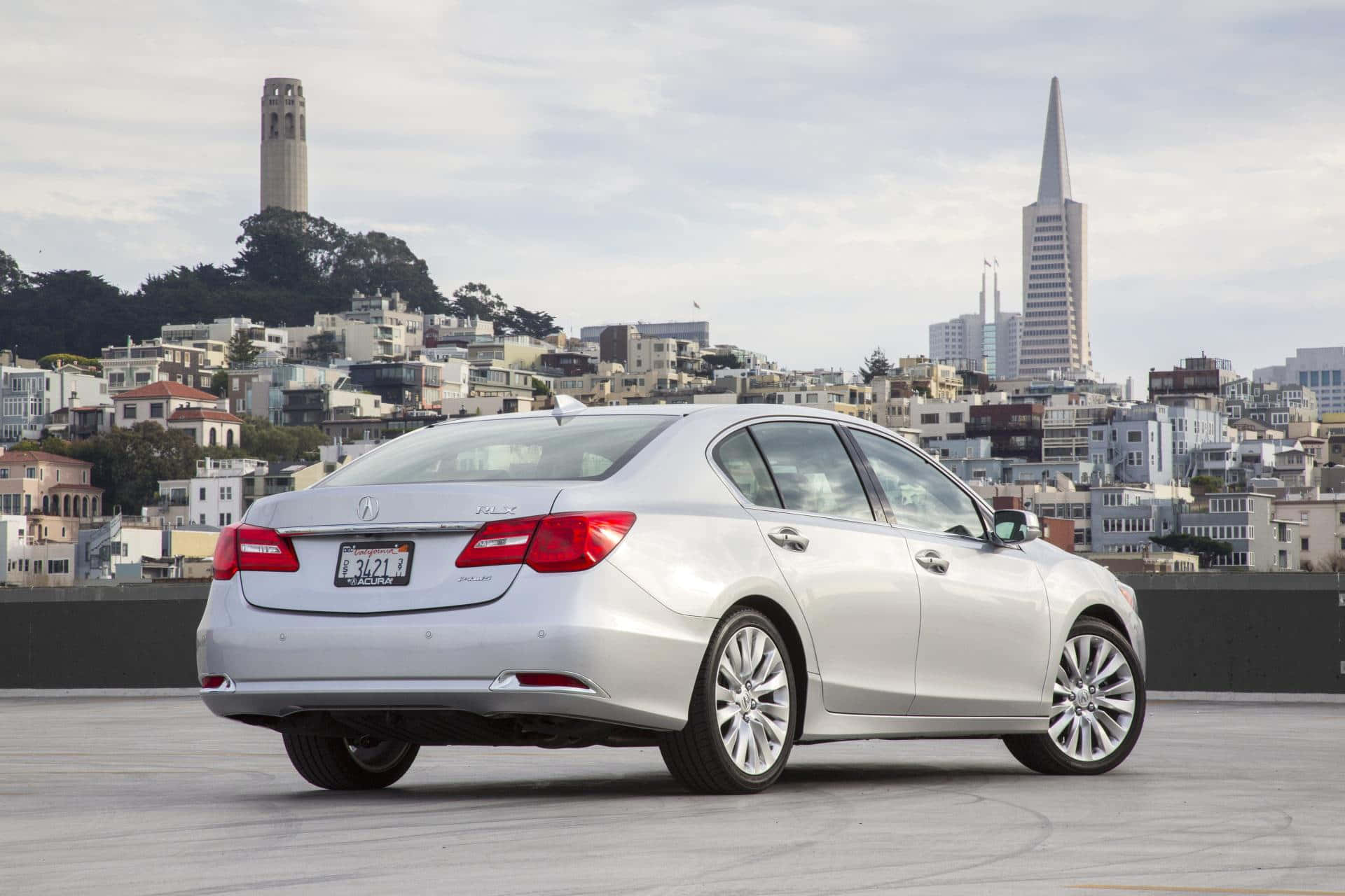 Acura Rlx 桌布 壁紙 — 一輛銀色轎車停泊在屋頂上，俯瞰三藩市標誌性的天際線，可見科伊特塔和泛美金字塔。