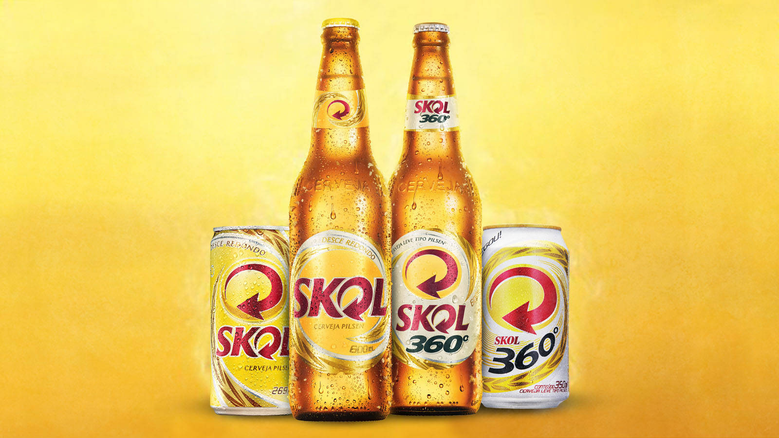四瓶Skol啤酒瓶和罐子在金色背景下帶有冷凝水珠。