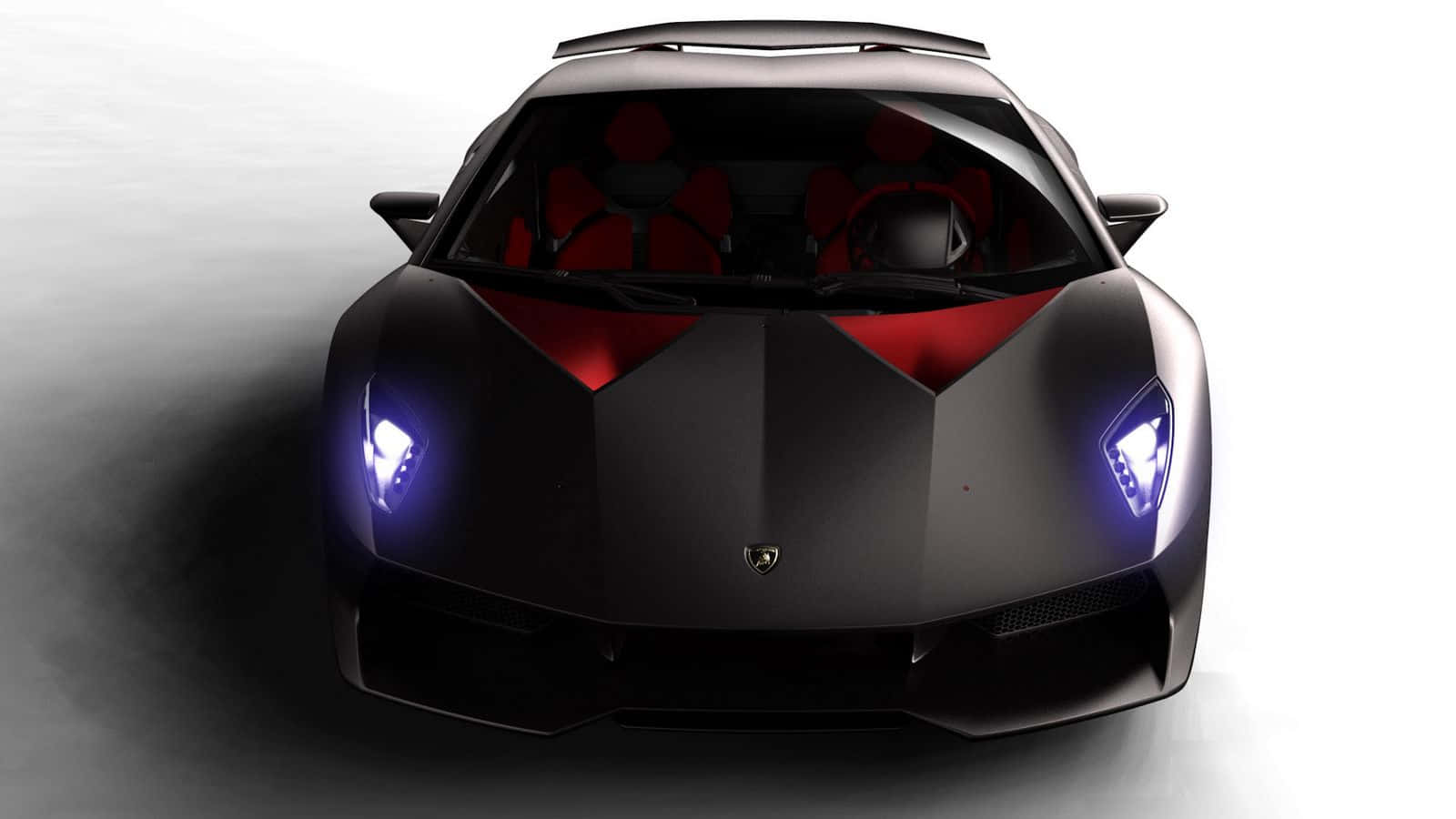 Lamborghini Sesto Elemento 桌布 壁紙 — 從上方俯瞰，一輛時尚的黑色林寶堅尼跑車，帶有發光的藍色車頭燈和紅色內飾，背景為漸變灰色。