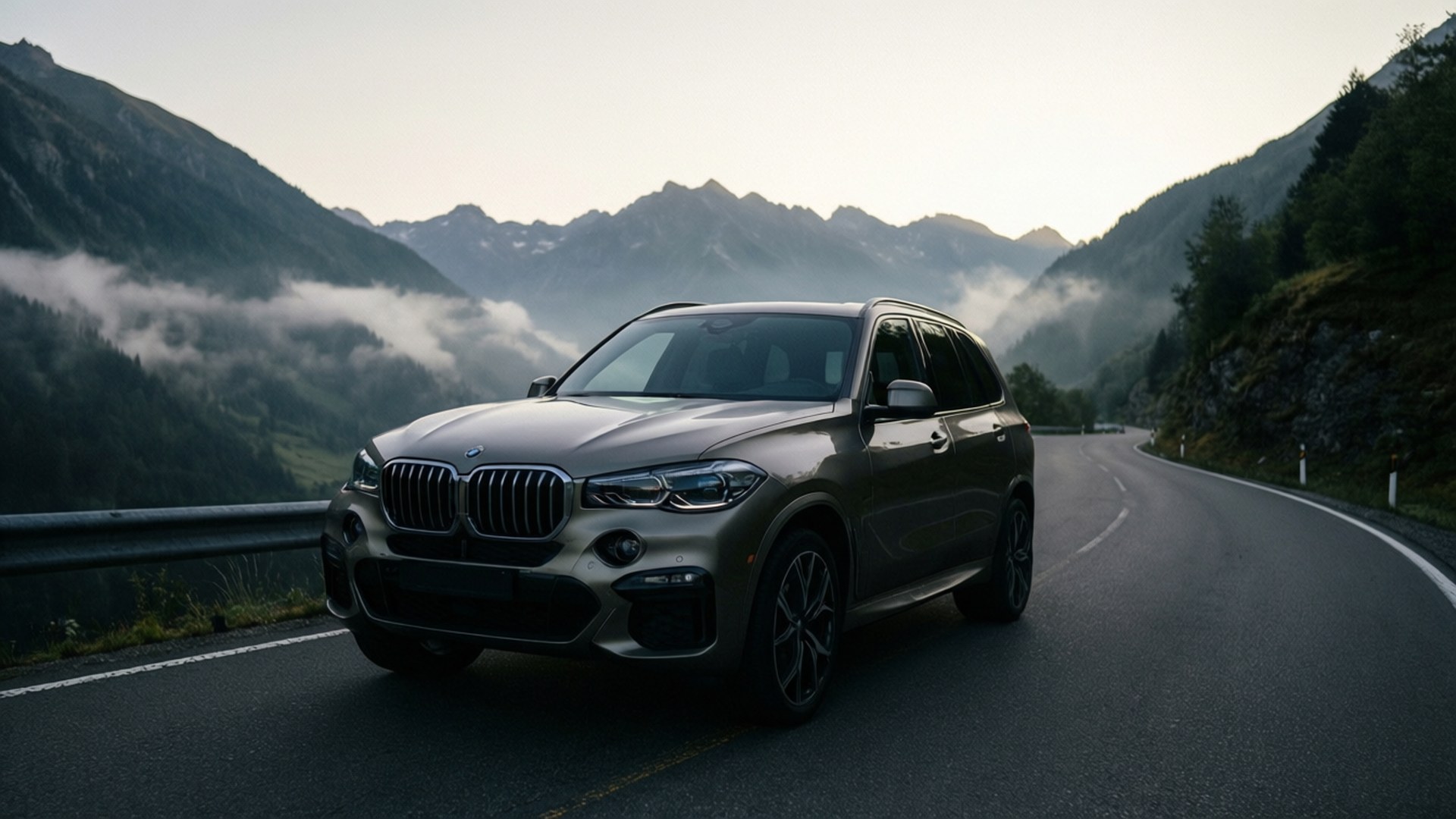 灰色BMW SUV在山路上，山谷有霧