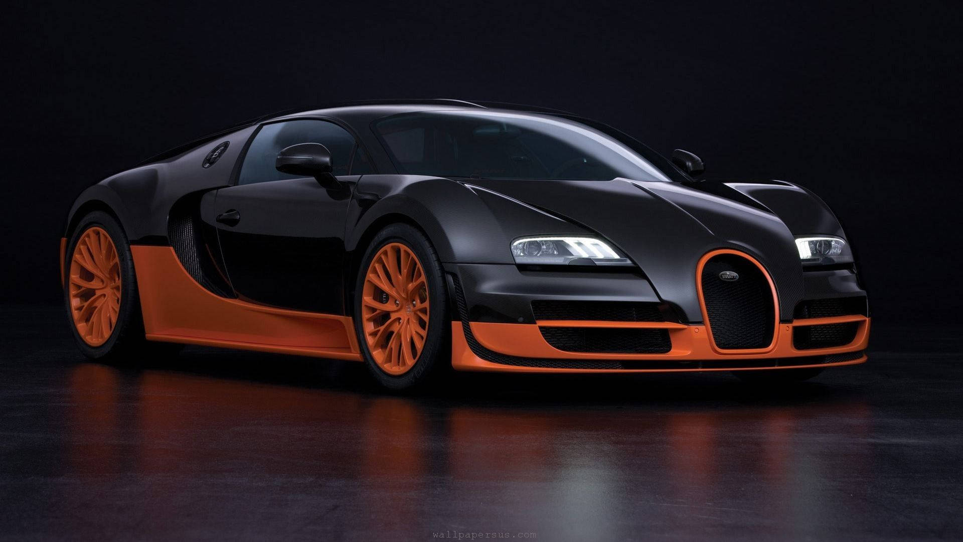 啞光黑色Bugatti Veyron，配橙色輪圈和點綴，在攝影棚燈光下。