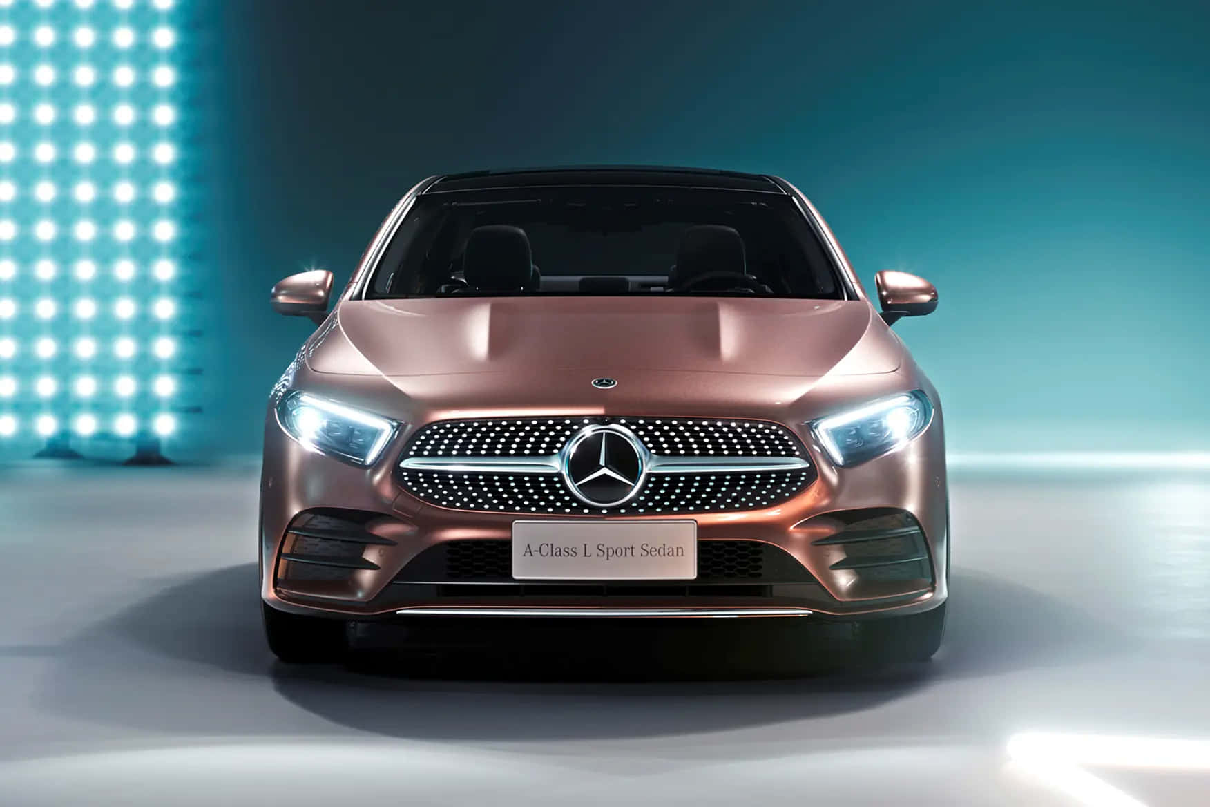 Mercedes Benz A-class 桌布 壁紙 — 一輛時尚的玫瑰金色平治A-Class房車在攝影棚燈光下閃耀，背景是發光的藍色網格。