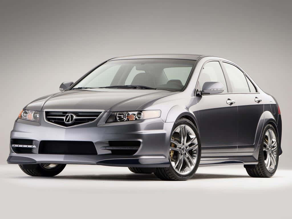 Acura Tsx 桌布 壁紙 — 一架時尚的銀色Acura轎車，配備定制合金輪圈和運動型前保險槓，在中性工作室背景下蓄勢待發。