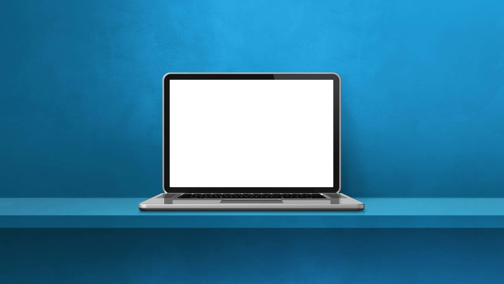 Computer Screen 桌布 壁紙 — 一部時尚的銀色手提電腦，配備空白白色屏幕，放置在藍色層架上，背景為有紋理的藍色牆壁。