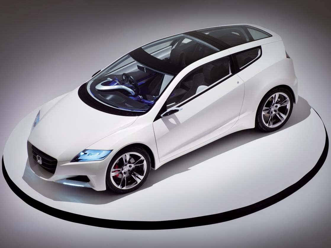 Honda Cr-z 桌布 壁紙 — 一輛時尚的白色概念車，帶有發光的藍色車頭燈和黑色飾邊，在極簡圓形平台上展示。