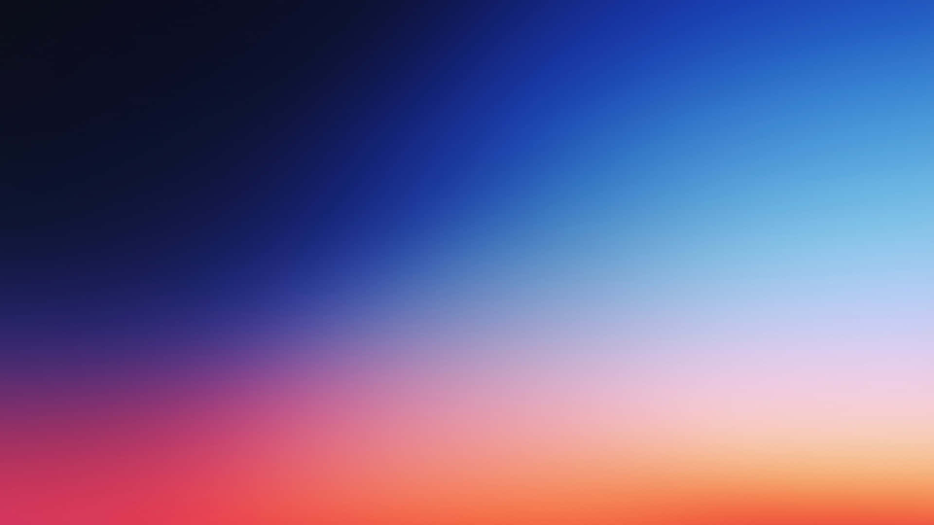  壁紙 — 平滑漸變的天空，從深藍色過渡到充滿活力的橙色和粉紅色調。
