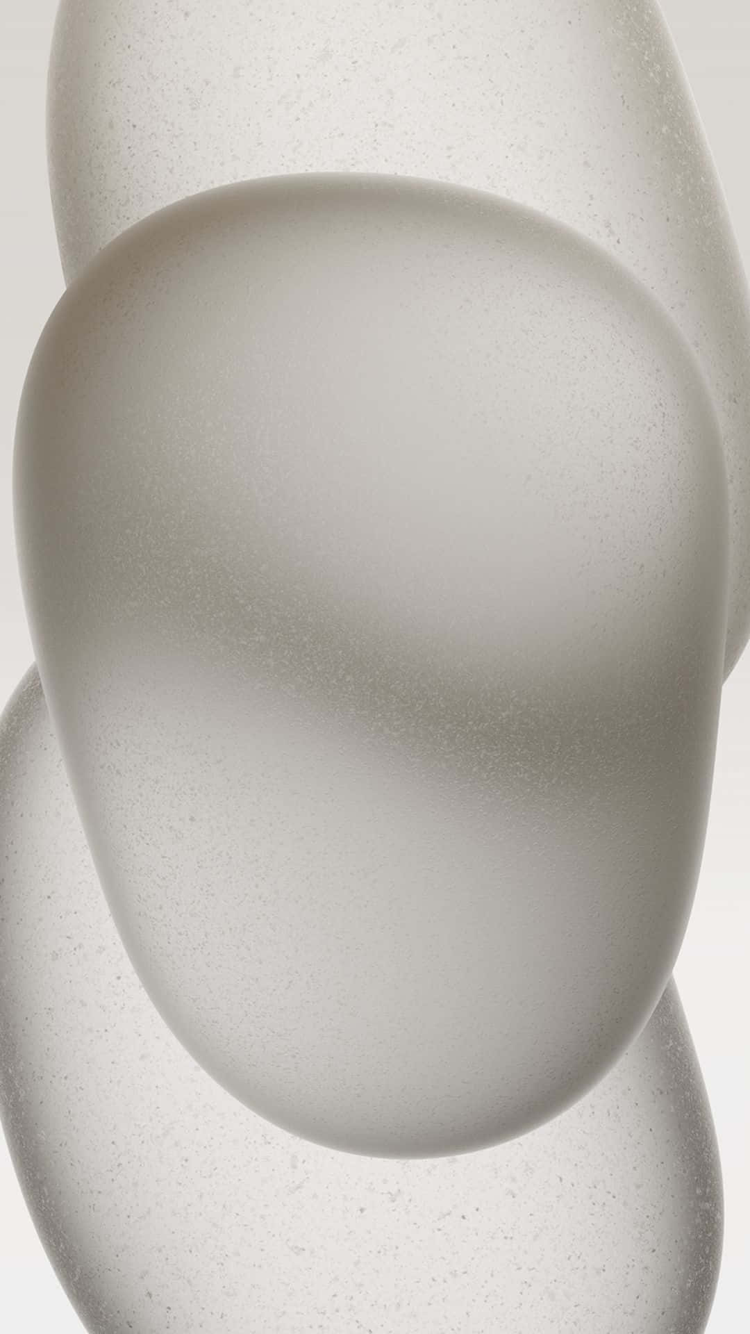  壁紙 — 光滑的半透明玻璃球體帶有嵌入的斑點，柔和地重疊在中性背景上。