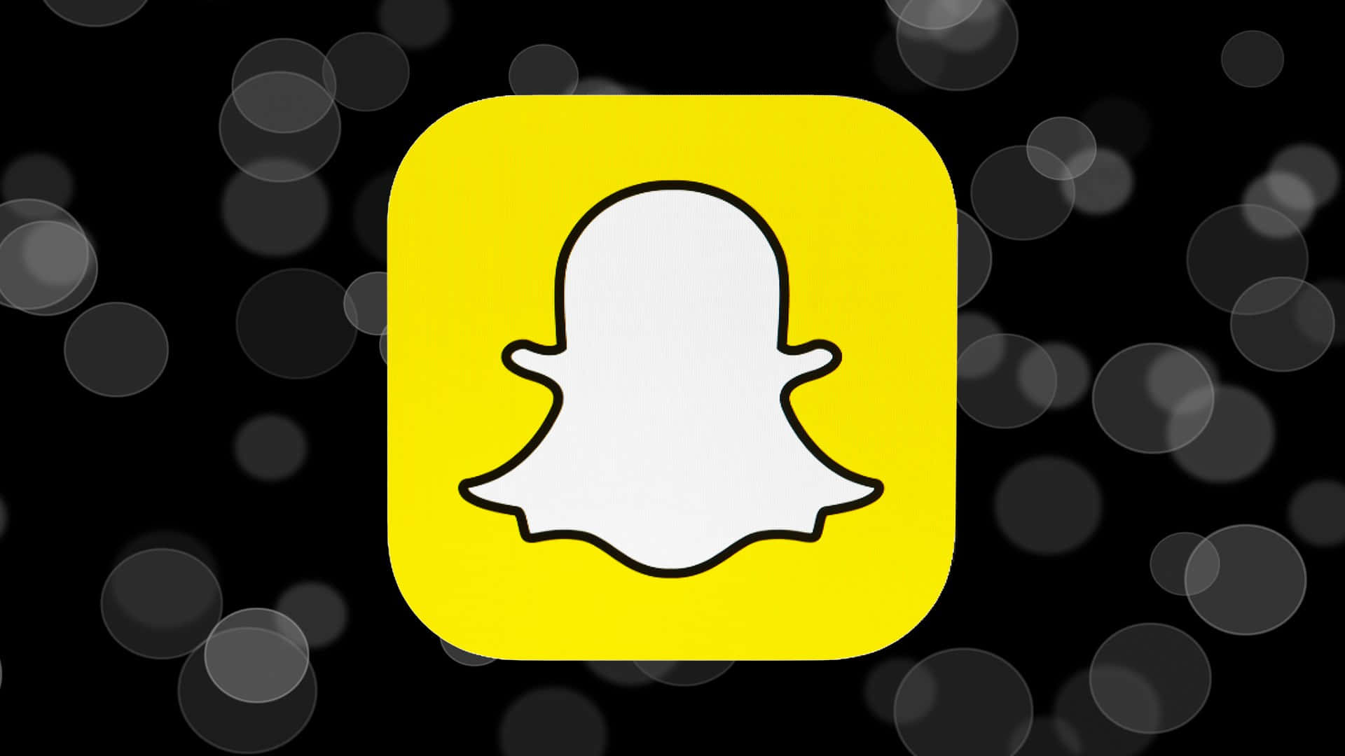 Snapchat應用程式標誌，帶有鬼魂圖標，背景為黑色散景