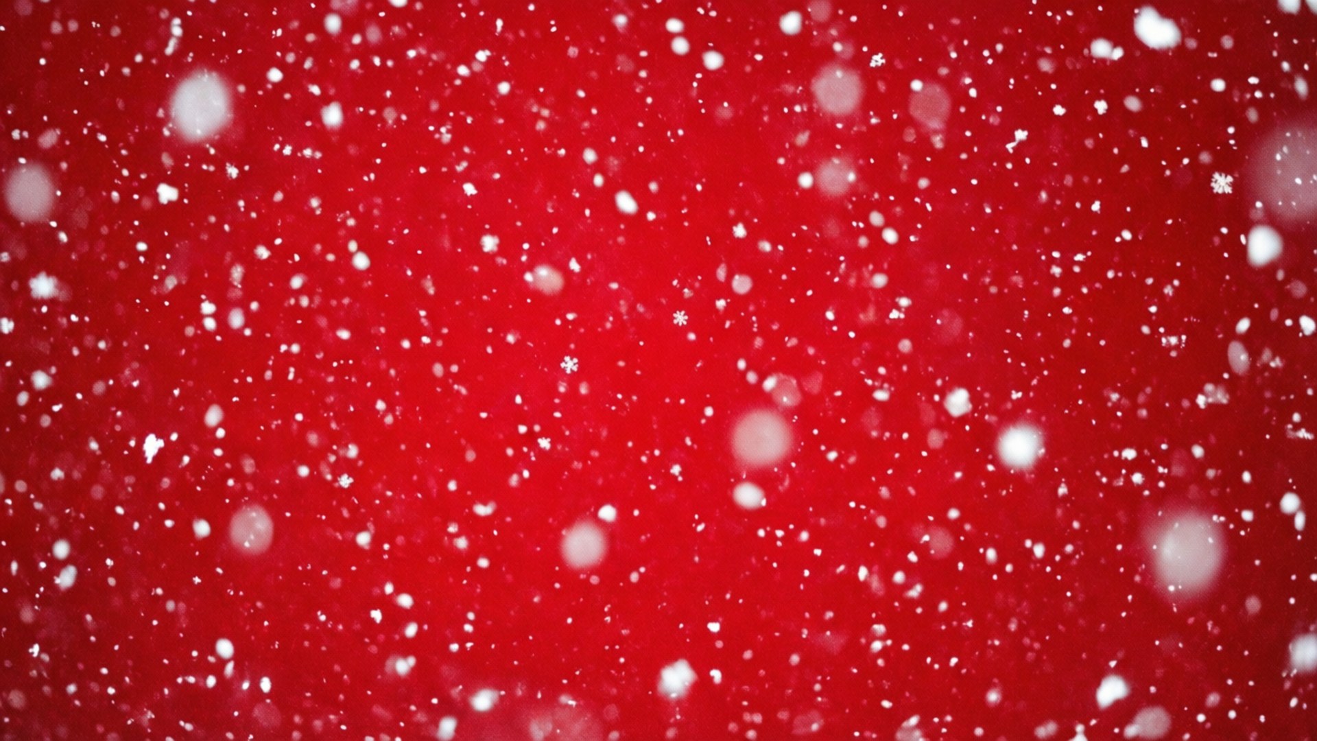 雪花落在紅色背景上，用於節日慶祝