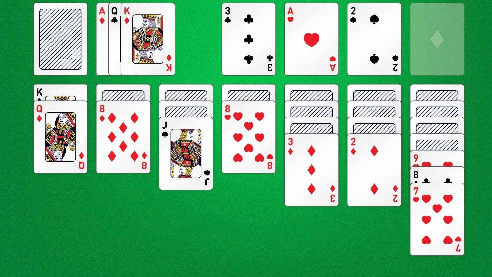 Solitaire遊戲紙牌 壁紙 — 在綠色絨面表面上展開的撲克牌，顯示遊戲佈局中的各種花色和點數。
