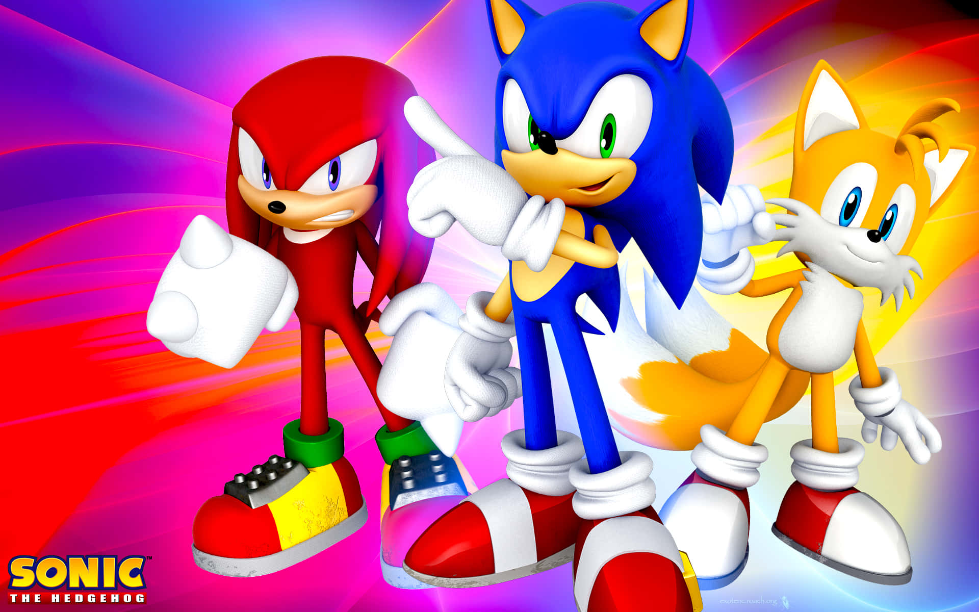 Sonic The Hedgehog Characters 桌布 壁紙 — Sonic the Hedgehog Knuckles 和 Tails 在充滿活力的彩虹條紋背景前動態擺姿勢。