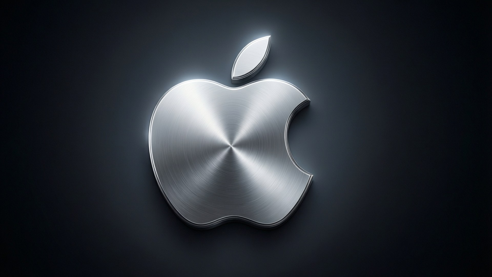閃亮的拉絲金屬 Apple 標誌在深色背景上發出柔和光芒