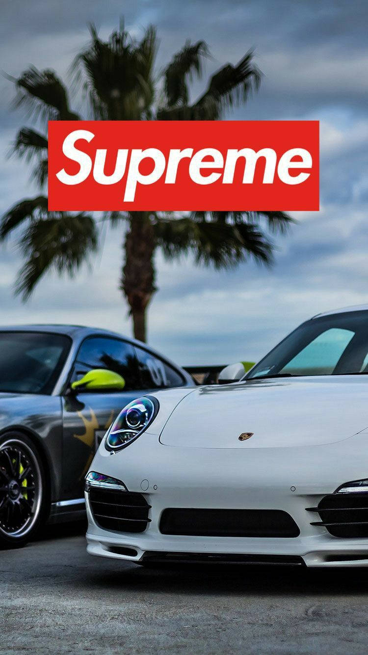 白色和灰色的跑車停泊在棕櫚樹下，並帶有Supreme標誌疊加。