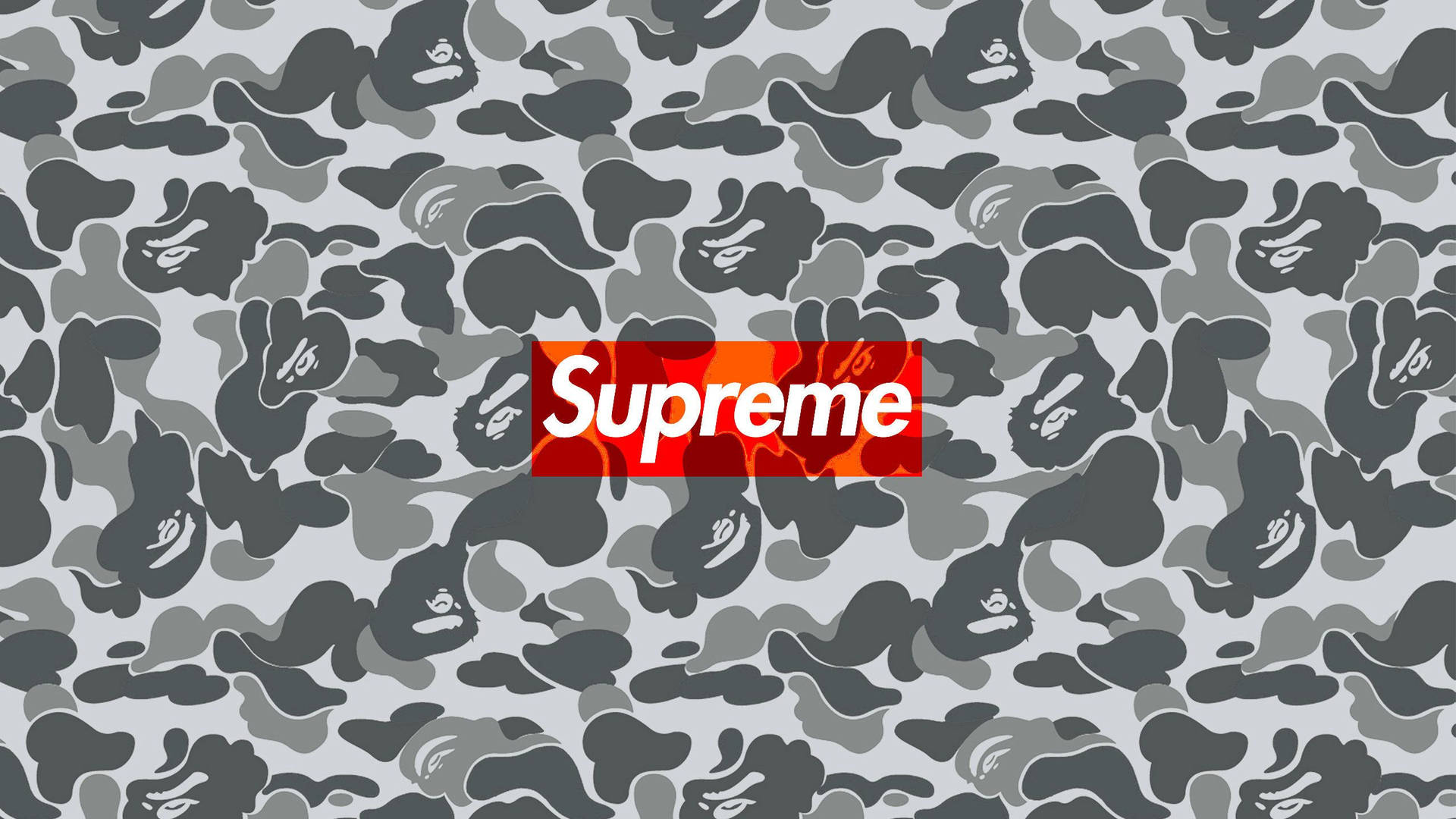 Supreme標誌在灰色迷彩背景上，帶有猿頭圖案