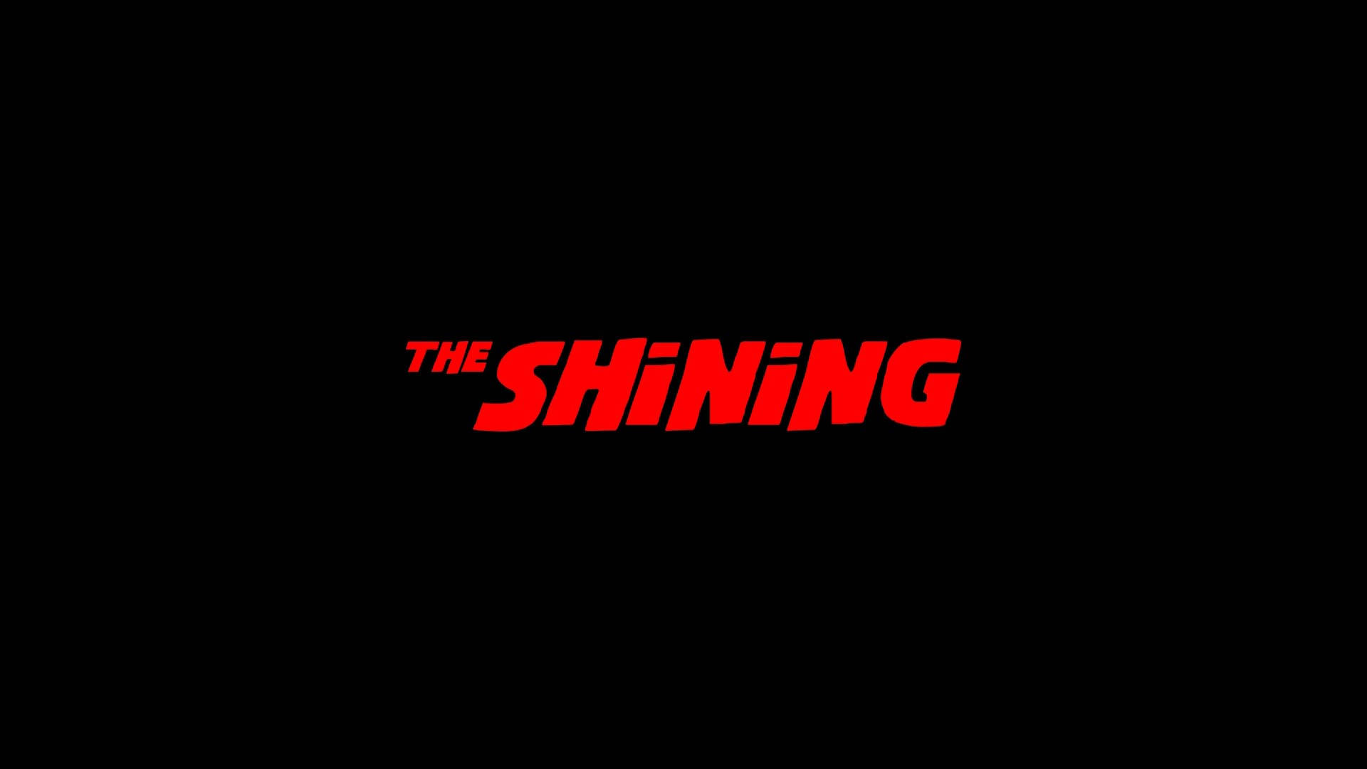 《The Shining》文字海報 壁紙 — 粗體紅色 'THE SHINING' 標題，採用風格化字體，居中於簡潔的黑色背景上。