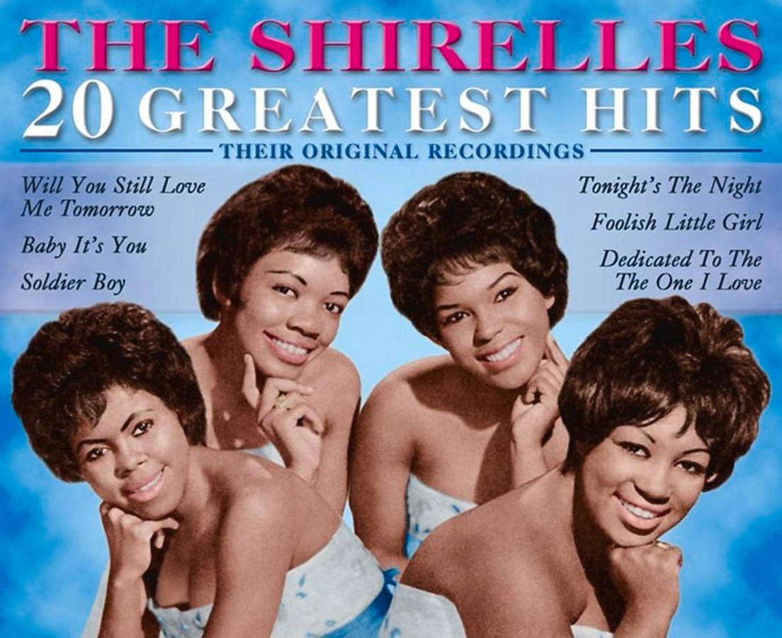 The Shirelles《20 Greatest Hits Compilation》2005年專輯封面 壁紙 — 四位微笑的1960年代女歌手在明亮的藍色背景前擺姿勢，出現在復古專輯封面上。